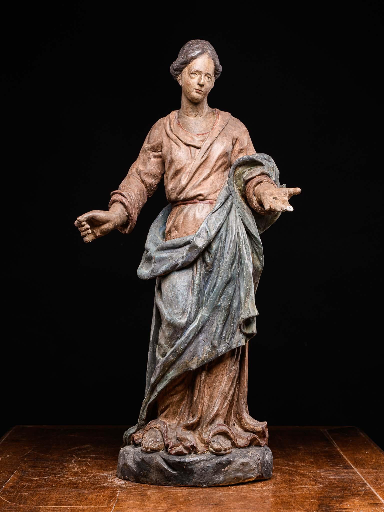 An exceptionally beautiful antique French wood carving, made in the 17th century. It depicts Madonna standing with open offering arms .The contemplative oval face, the finely carved hairdo and intricate arrangement of the pleats of her dress lend