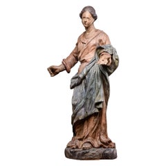 Estatua tallada en madera de frutal policromada del siglo XVII que representa a una Virgen, Francia
