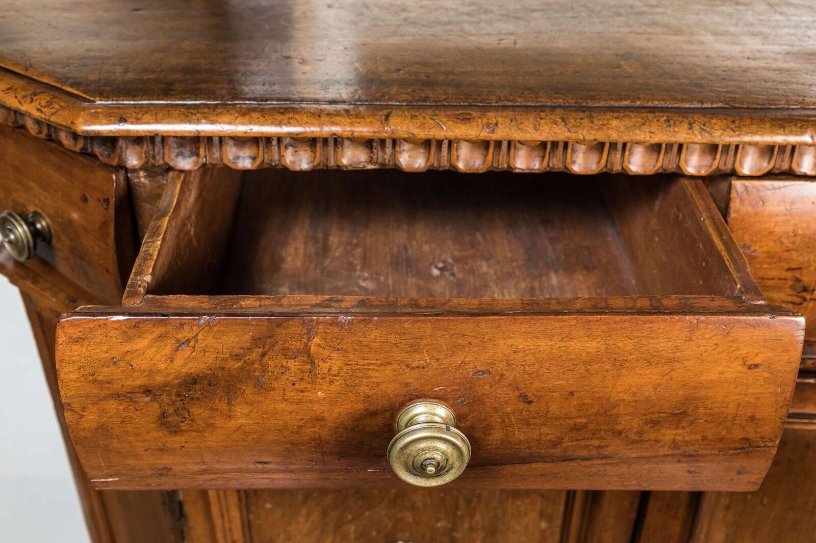 Wonderful, four-drawer, two-door, clipped corner, walnut, high-boy style cabinet on a raised base. The whole crowned with a convex upper tier surmounted by an egg-and-dart molding.