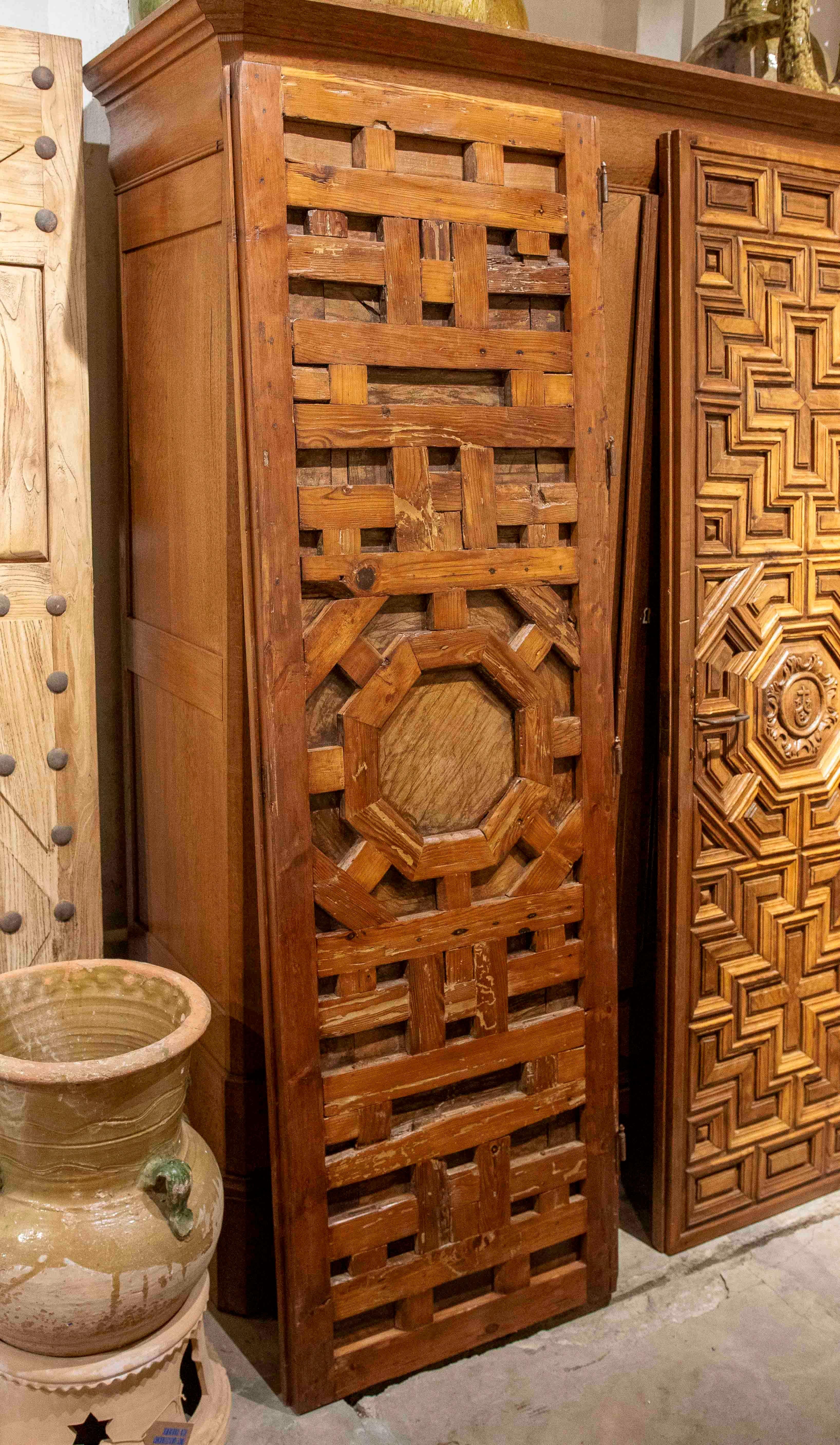 17th Carved Wooden Door with Mudejar Geometric Motif and Central Emblem For Sale 9