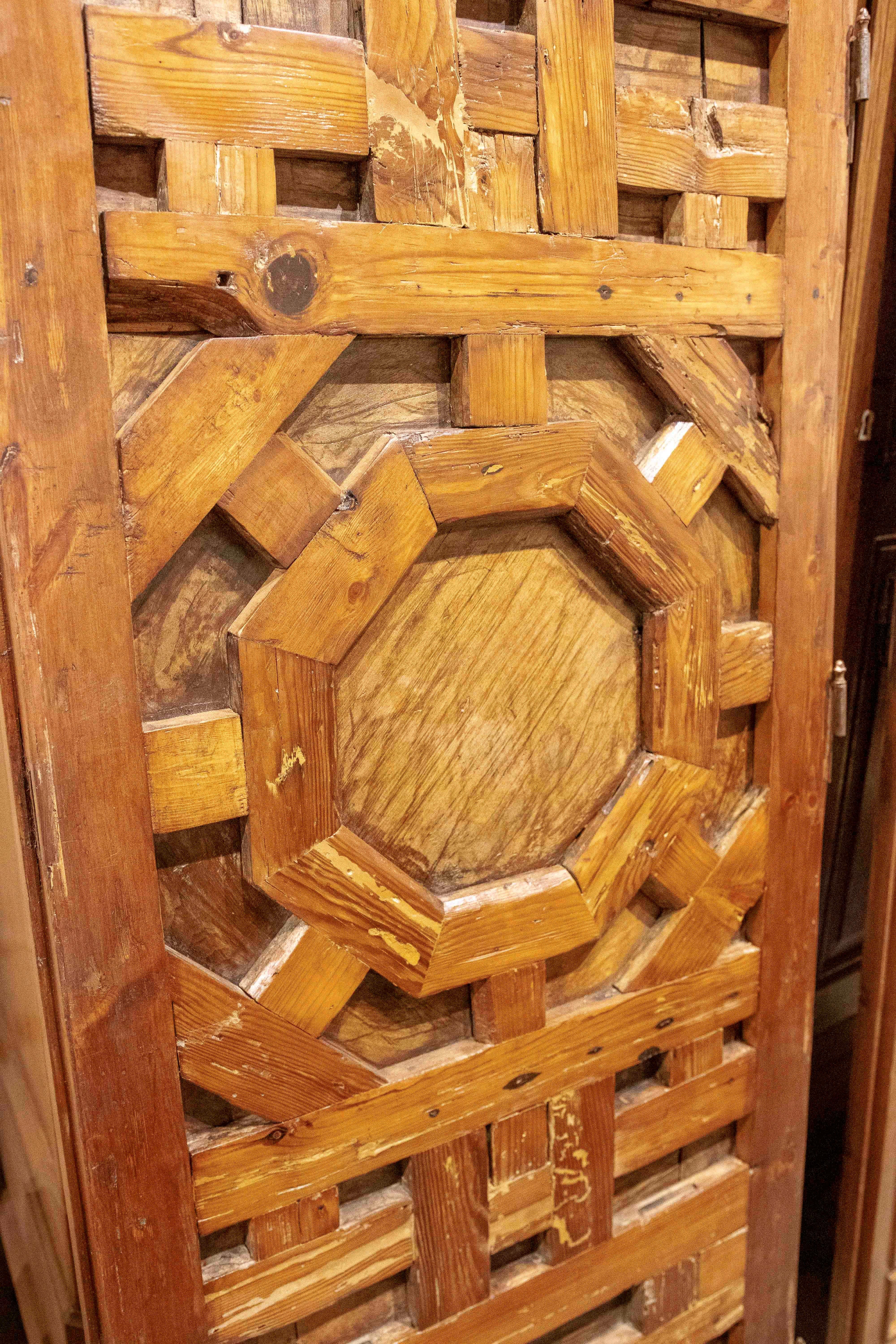 17th Carved Wooden Door with Mudejar Geometric Motif and Central Emblem For Sale 10