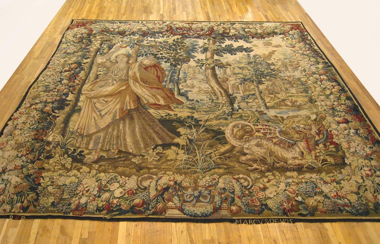 A Baroque Brussels tapestry from the 17th century, signed by Marcus de Vos, depicting Proserpine (Persephone) reaching for a pomegranate and on the right side a dragon, probably from the chariot of Ceres, within a dense landscape; a satyr watches