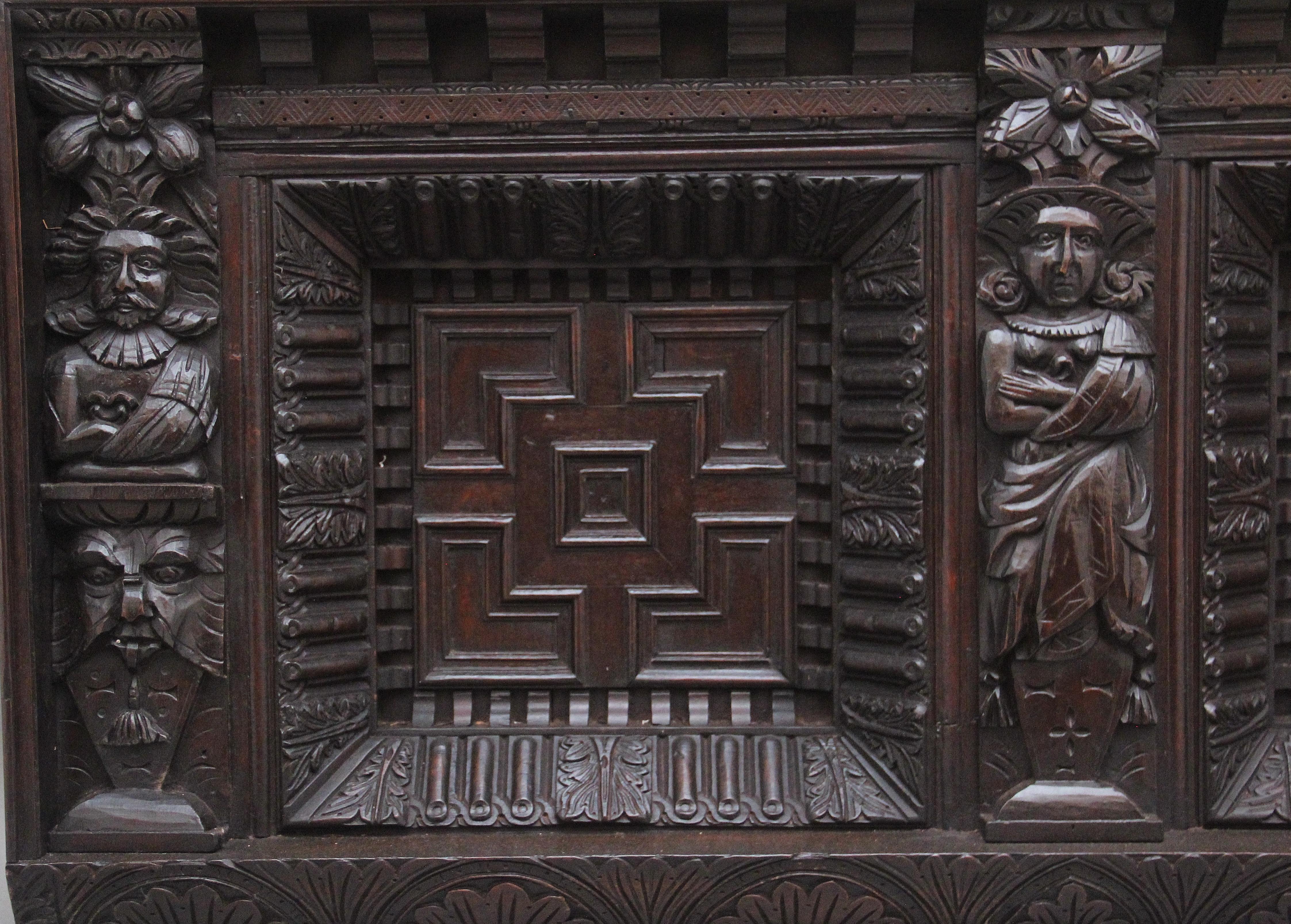 A large 17th Century and later carved oak overmantle, consisting of two moulded front panels with intricate carved leaf and fluted decoration, carved figures and grotesque masks flanking each panel.  Wonderful carving and in very good condition. 