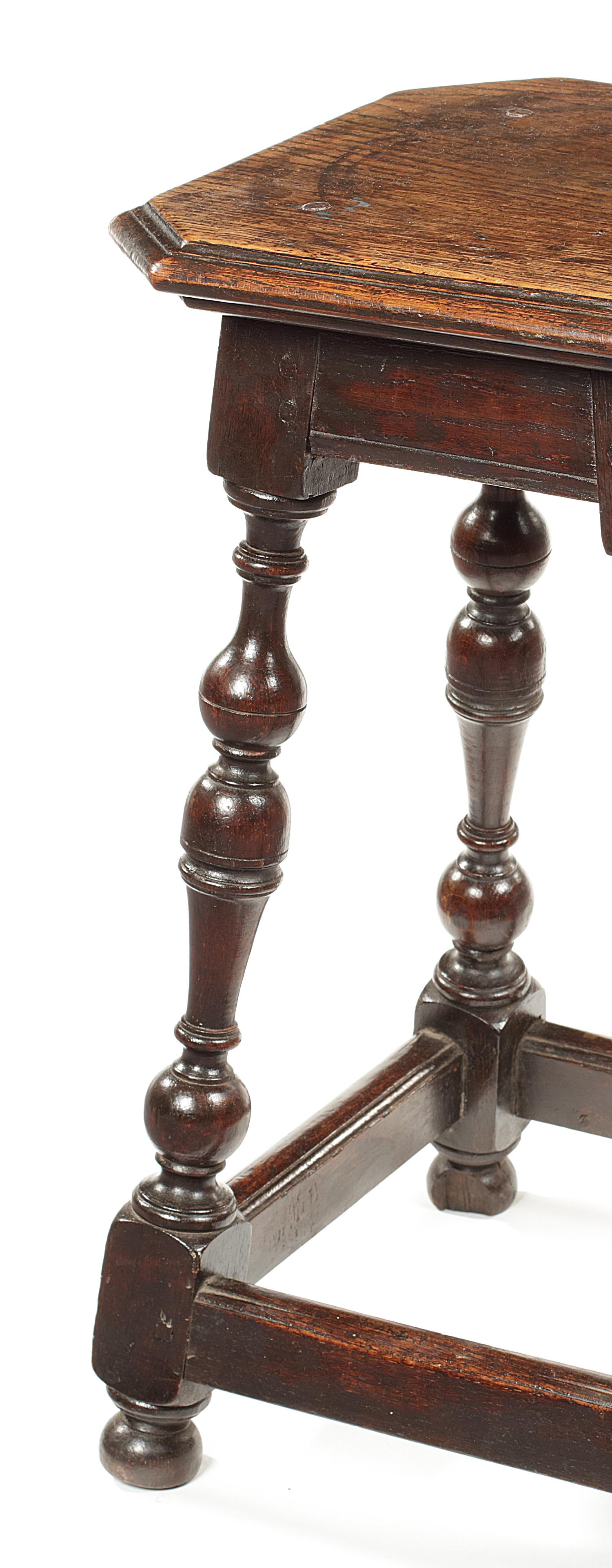 17th century and later oak joined stool
Of unusual design, with canted square top and tall baluster legs joined by moulded stretchers, 32cm square, 55.5cm high.