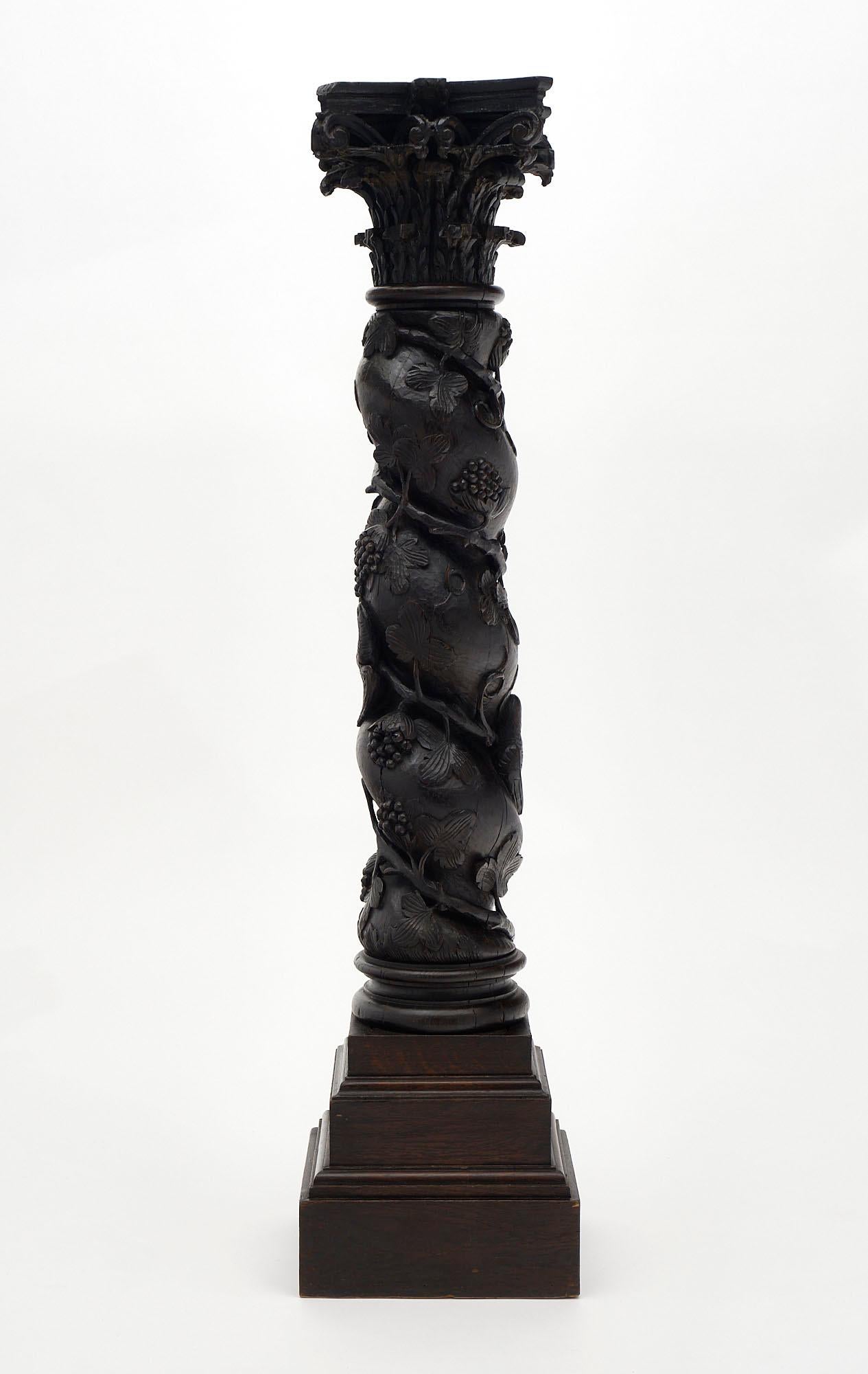 Column from 17th century France made of beautiful hand-carved and sculpted wood with pampre décor throughout and a Corinthian capital. This pedestal piece is in excellent antique condition and boasts a lovely patina to the wood.