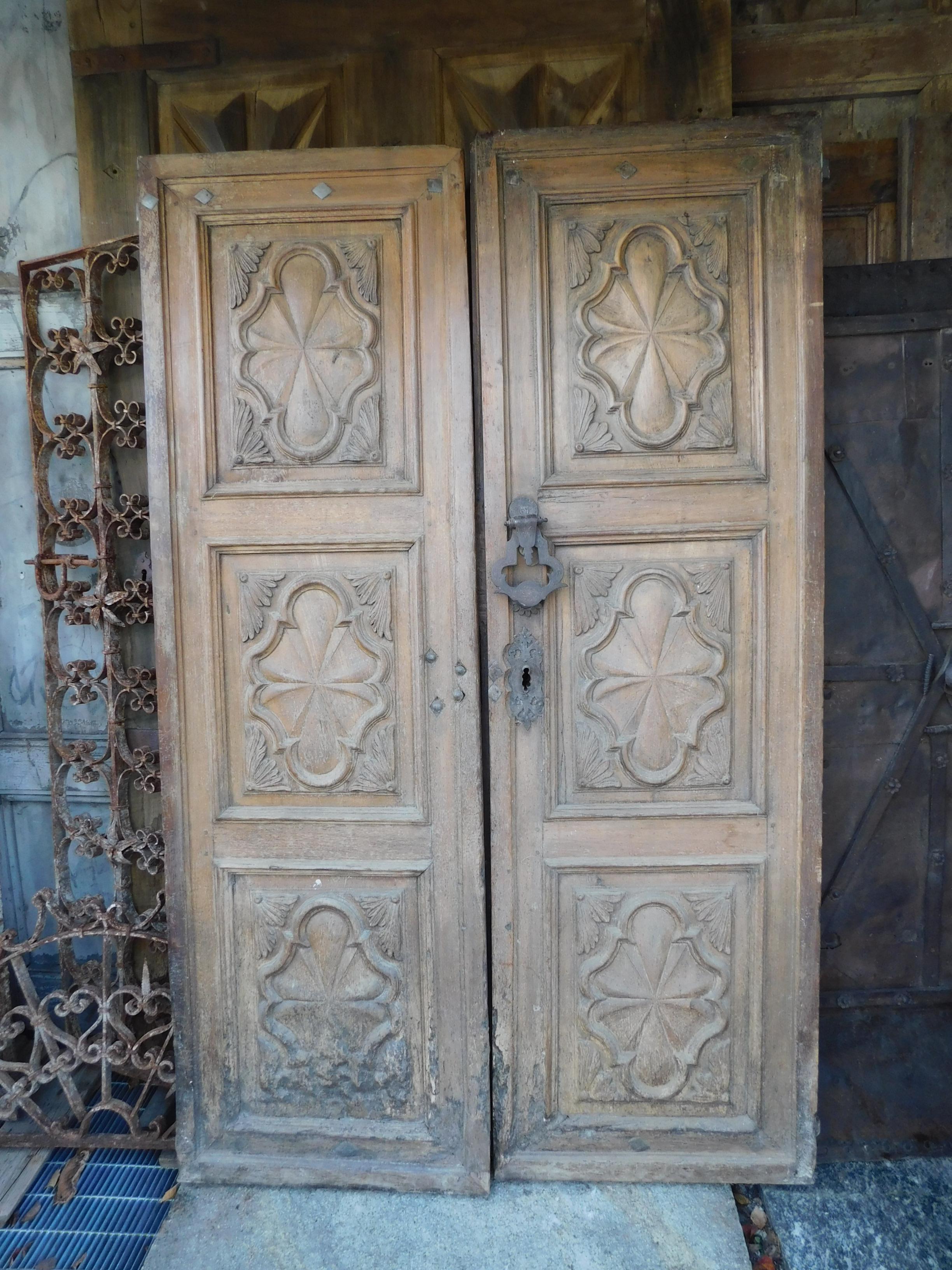 17th century antique entrance door, baroque decorations with 6 panels carved spiderweb motif, from a historic house in Northern Italy.