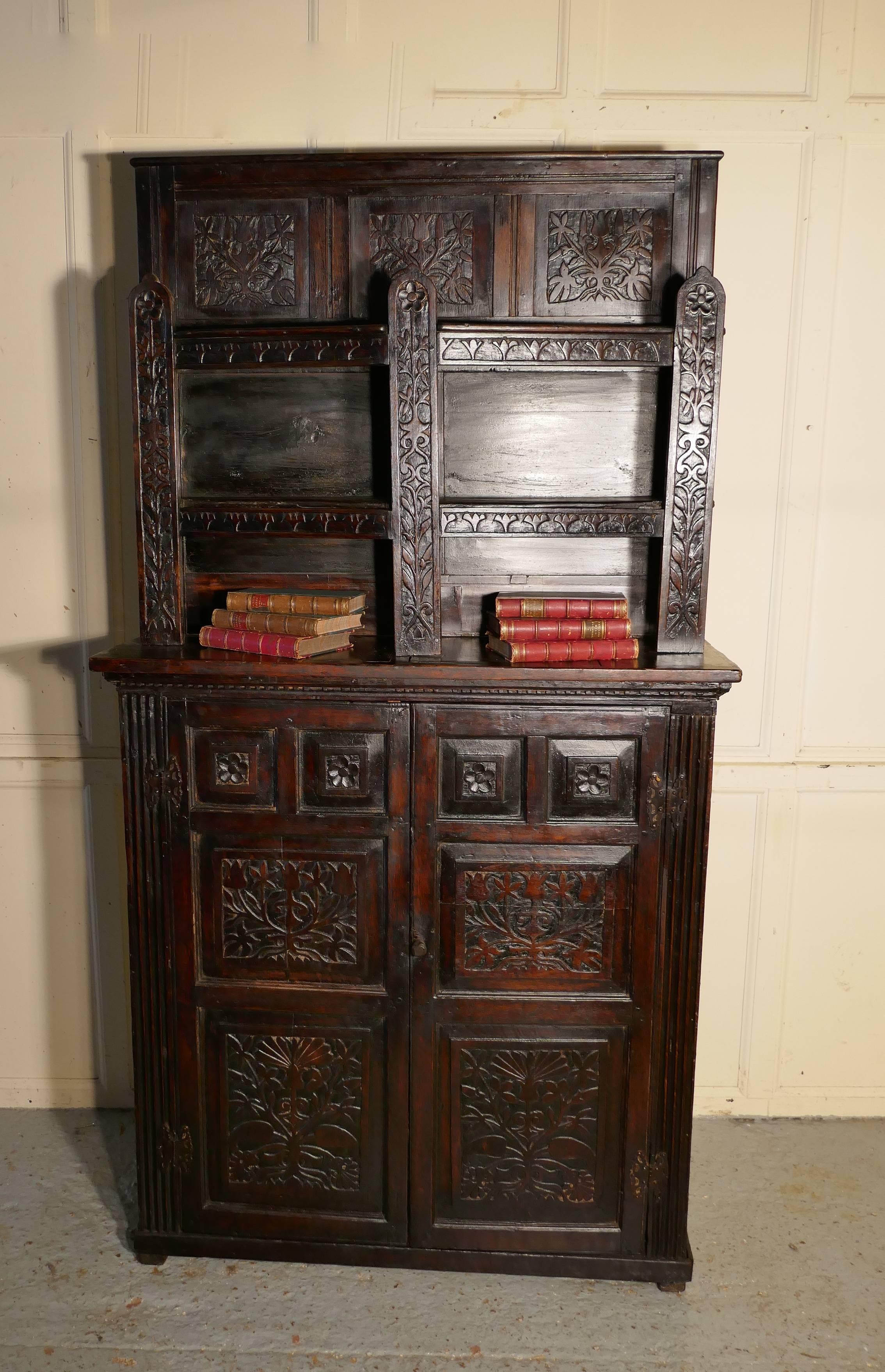 17th century antique housekeepers oak bookshelf cupboard

This is a very unusual antique cupboard, the upper part has a bowed shape and open shelves with a 
carved high galleried top and front rails. This is set on a shallow shelved cupboard
