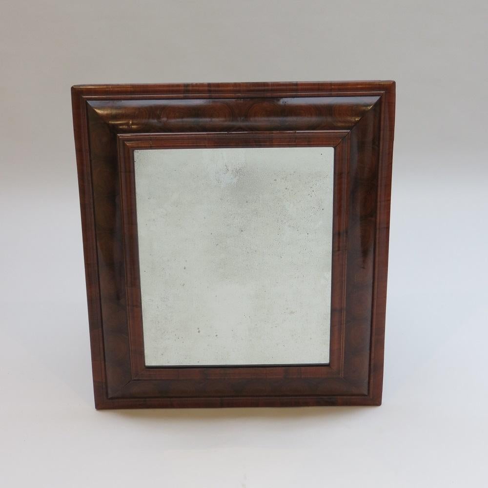 A 17th Century Olive Oyster Wood and cross grain moulding cushion mirror.

This is a wonderful Olive wood cushion mirror from the 17th Century, circa 1690.  Wonderfully proportioned frame with stunning Olive wood oyster veneers, in very good