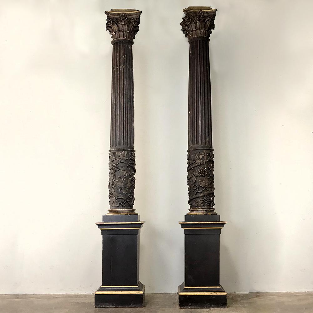 Over three centuries in age and hailing from Italy, this exquisite pair of Corinthian columns has been handcrafted and conscientiously rendered as pure representations the original ancient Greek models. Faithful capitals depict two tiers of acanthus