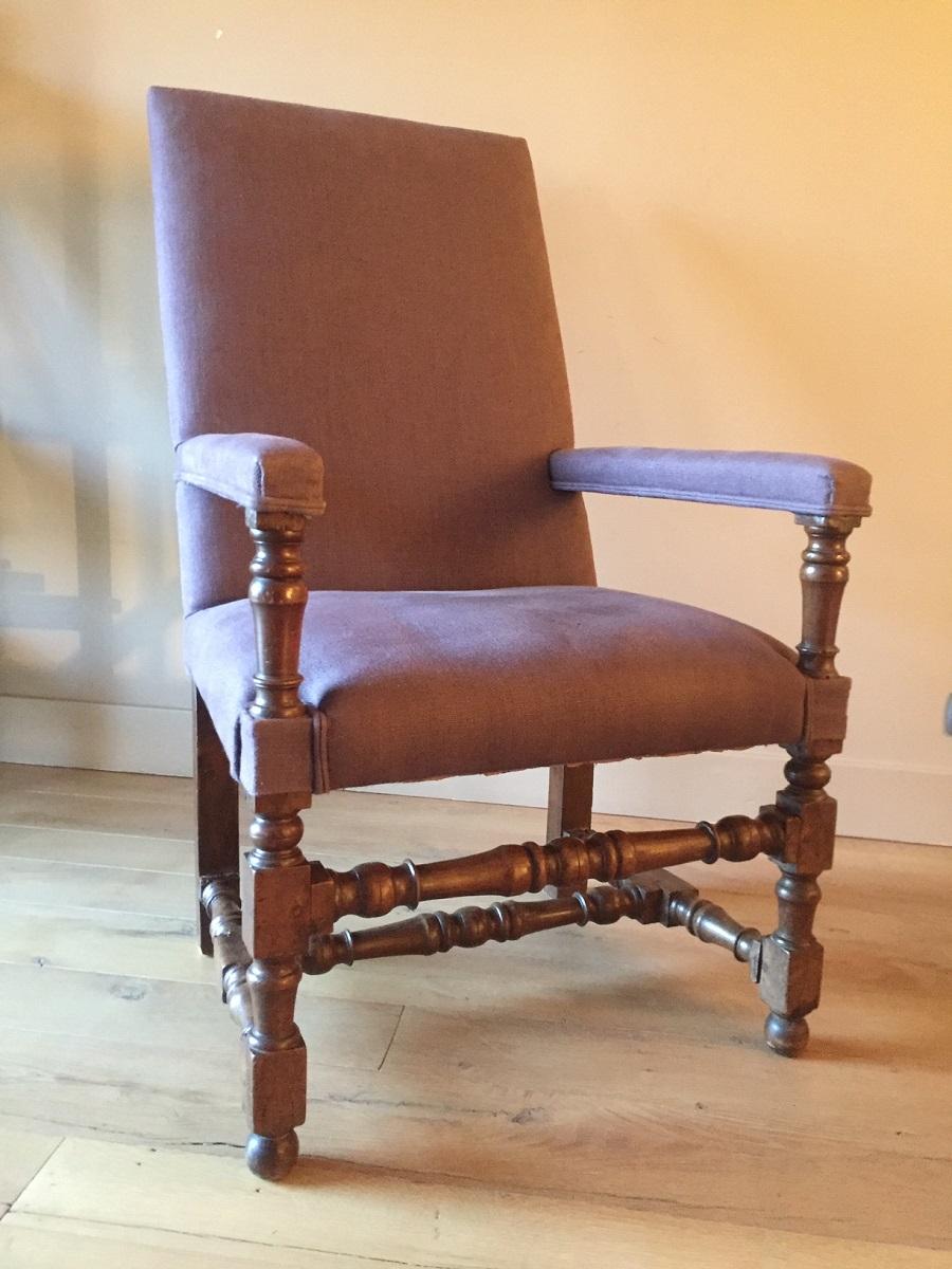 Great 17th century walnut armchair from the Louis XIII period. The proportions and turning quality are exemplary and are complimented with a lovely subtle patina. This armchair has been reupholstered with natural linen.
