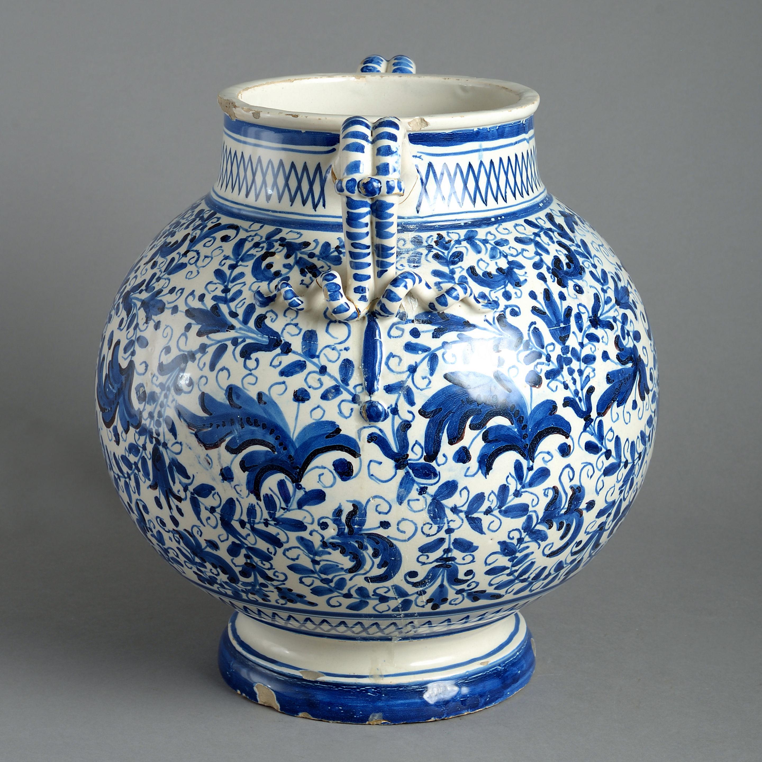 A late 17th century blue and white pottery vase of bulbous form, having two carrying handles and signed upon the underside. 

Condition: Some frits and minor restorations to handles.
  