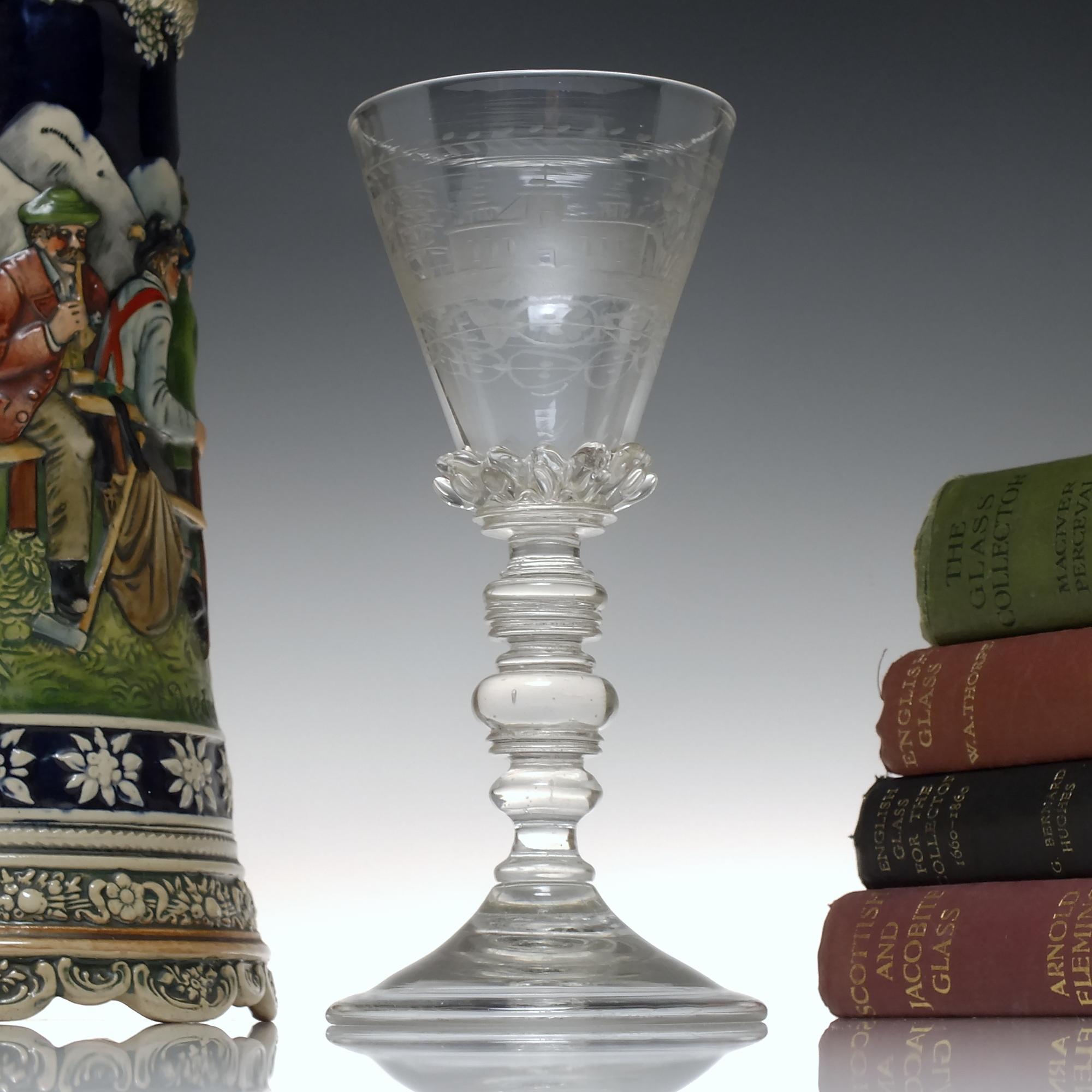 Technical Description

A fantastic 17th Century Bohemian glass goblet dating to between c1680-90.

It has a spiked gadrooned conical bowl with classic Bohemian engravings including castles, flowers, foliage and fruit. Sits on multi knopped stem