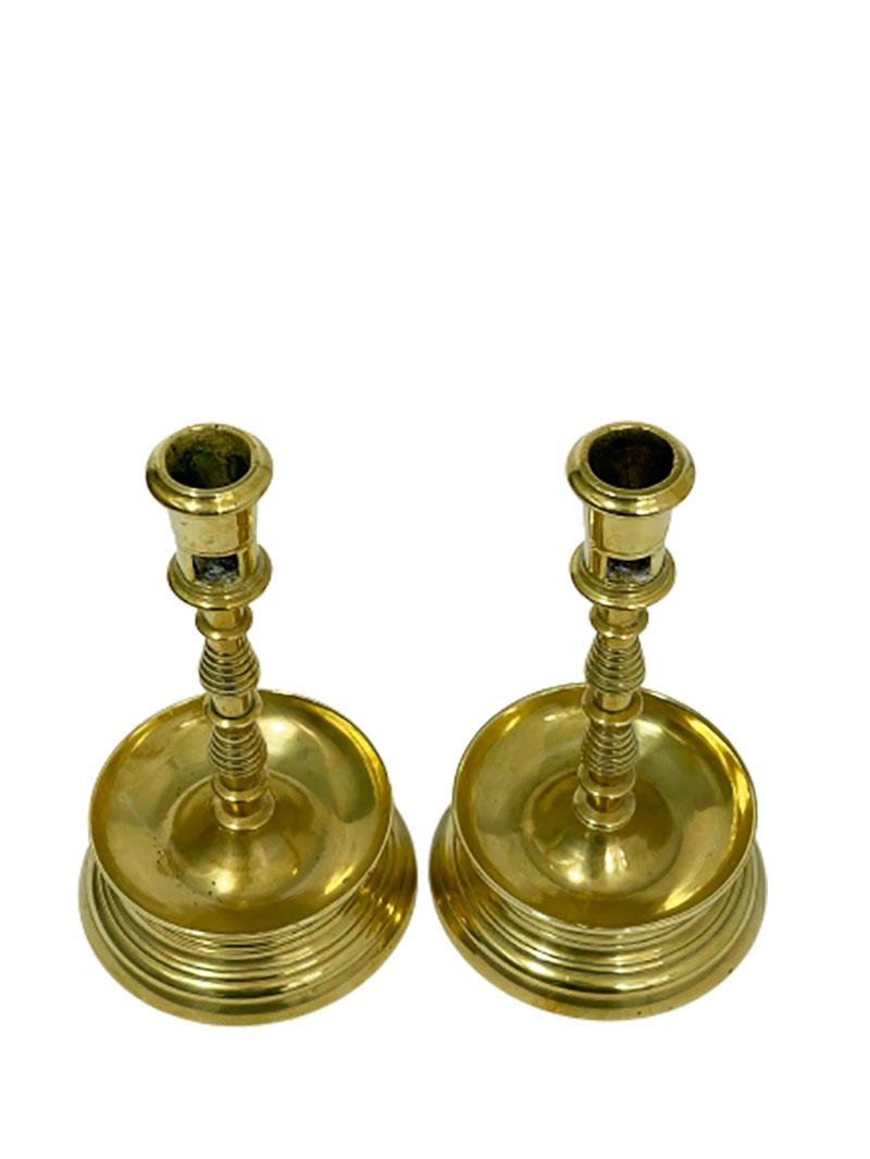 17th century brass capstan-candlesticks.

Brass ribbed knob capstan- candlesticks with rectangular apertures in the part of the candle holder

The candlesticks measures 22 cm high and 12.3 cm diagonal
1 candlestick weights 830 gram and the