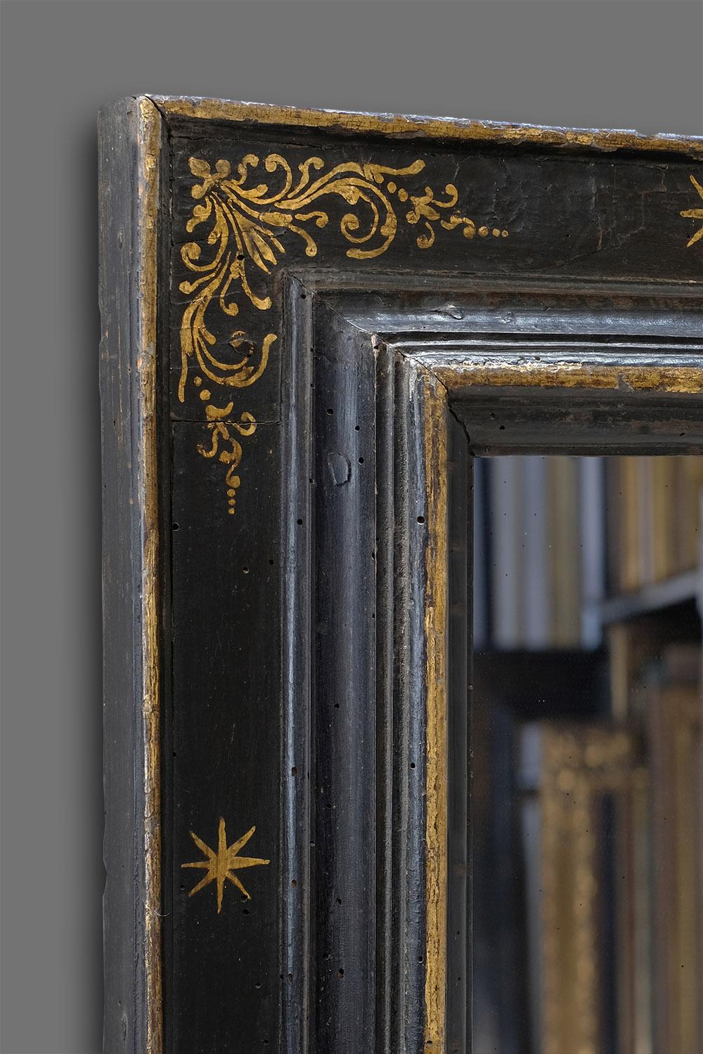 A beautiful 17th century hand carved Italian (Tuscan) reverse cassetta frame. It has bolection / architrave profile and a very well preserved parcel gilt finish: painted black with corner-&-centre arabesques and intermediate stars. Further