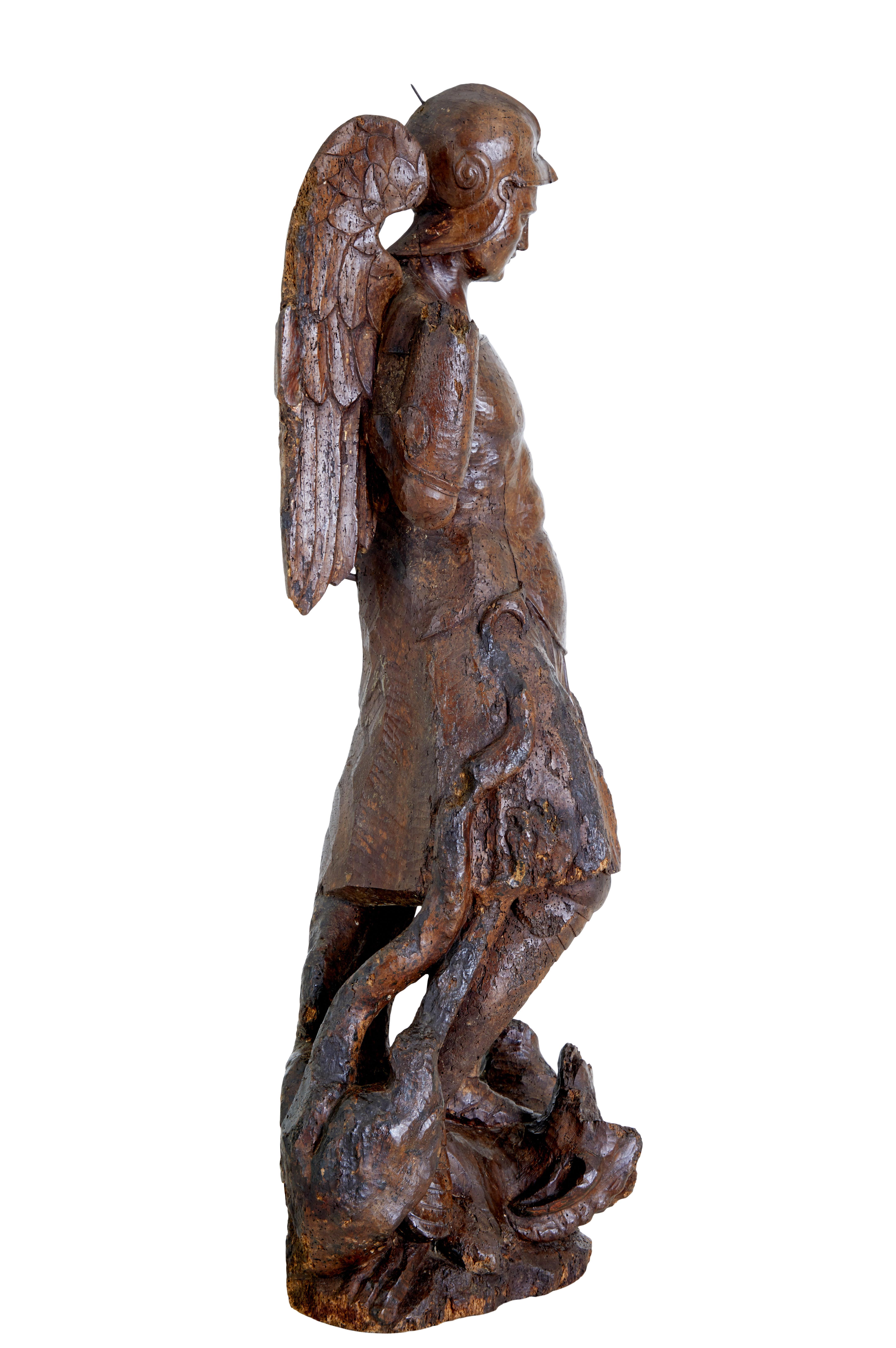 Carved 17th century carved limewood figure of St Michael For Sale