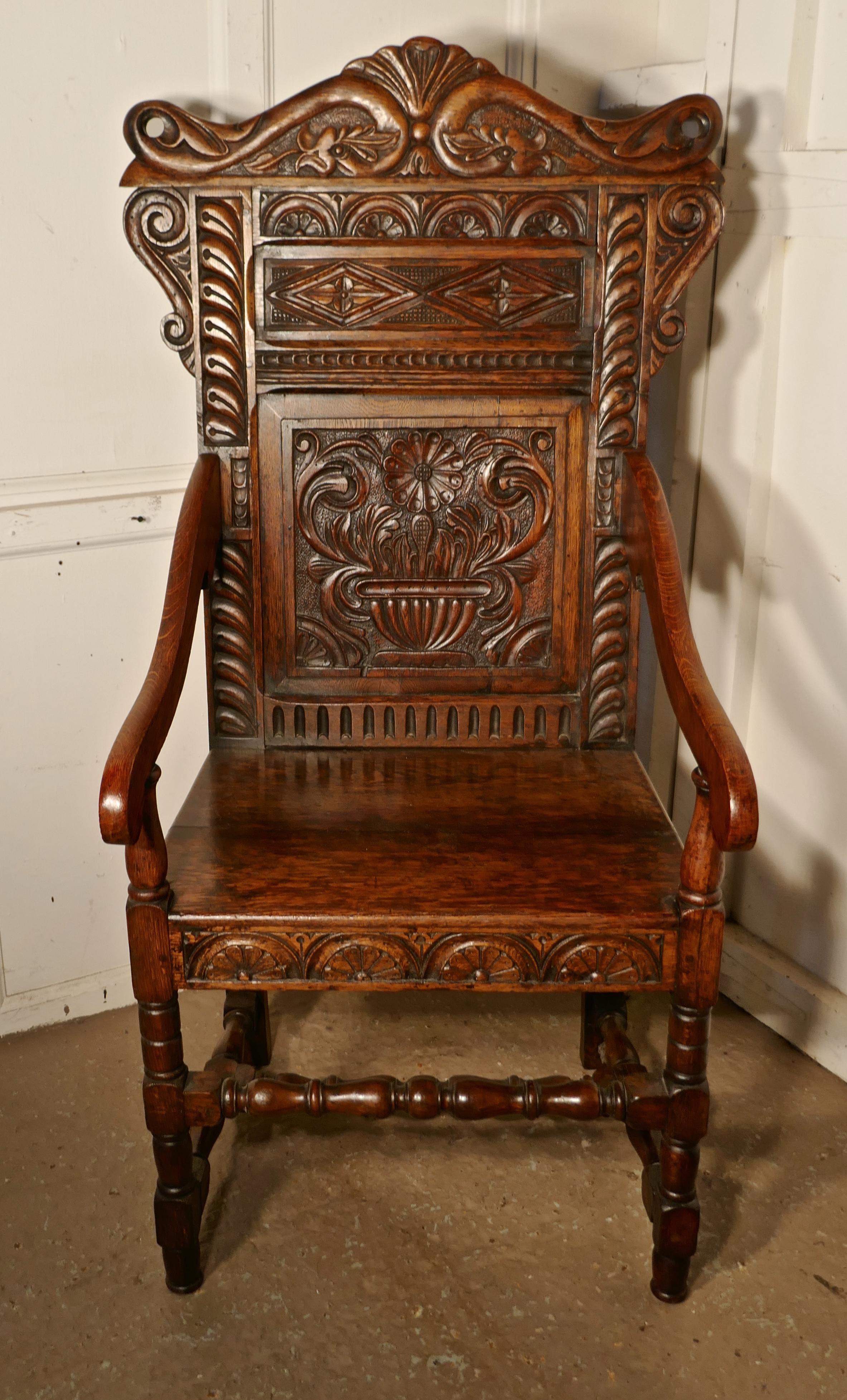 17th century carved oak wainscot chair

This handsome chair, has a magnificent patina, the solid plank seat has a carved border at the front, the turned legs and uprights support the arm rests, all set off with a decorative high throne back carved