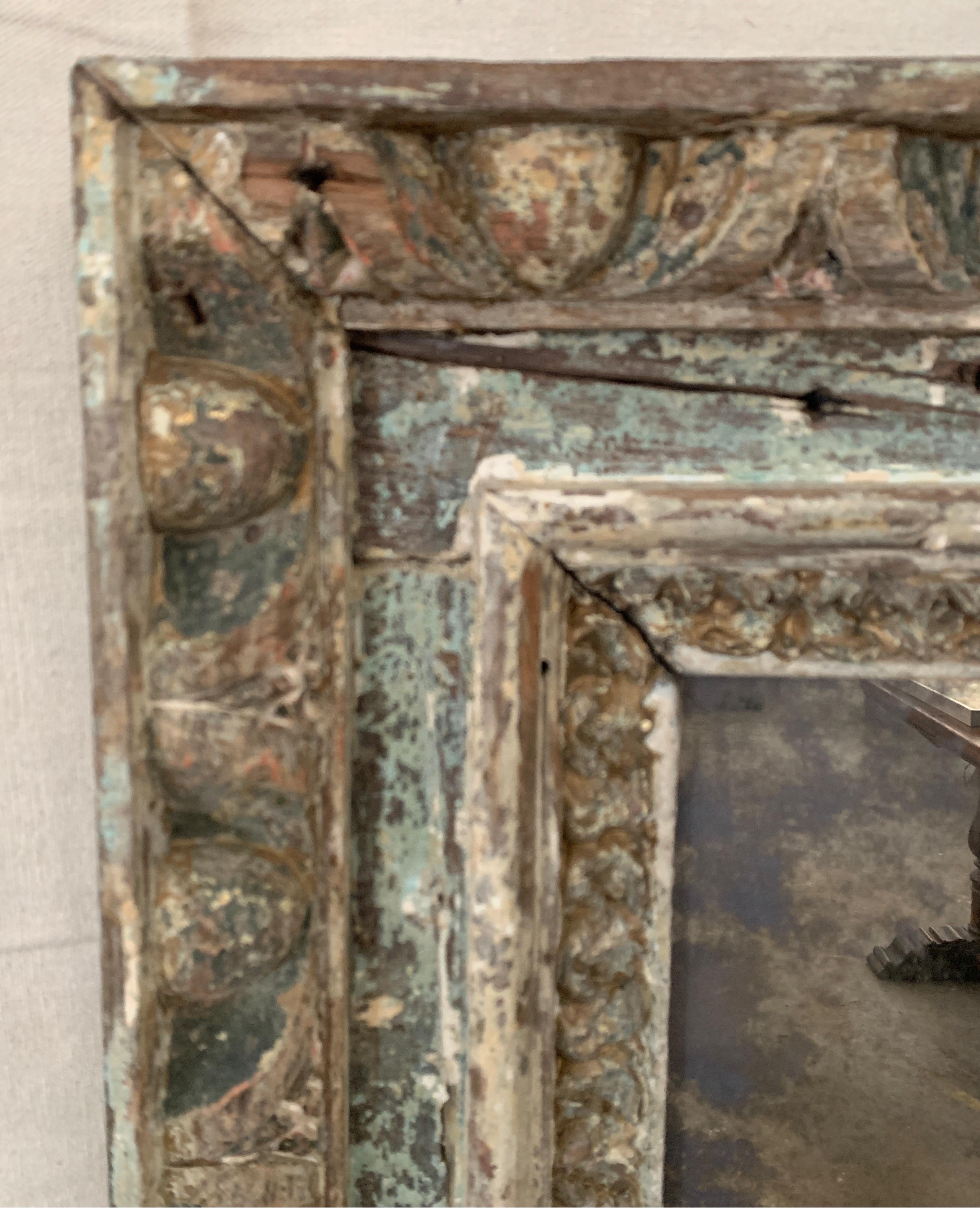 This was likely from a cathedral in Spain. It may have had a painting in it at one time. It has a replace mirror made to look distressed and old now.