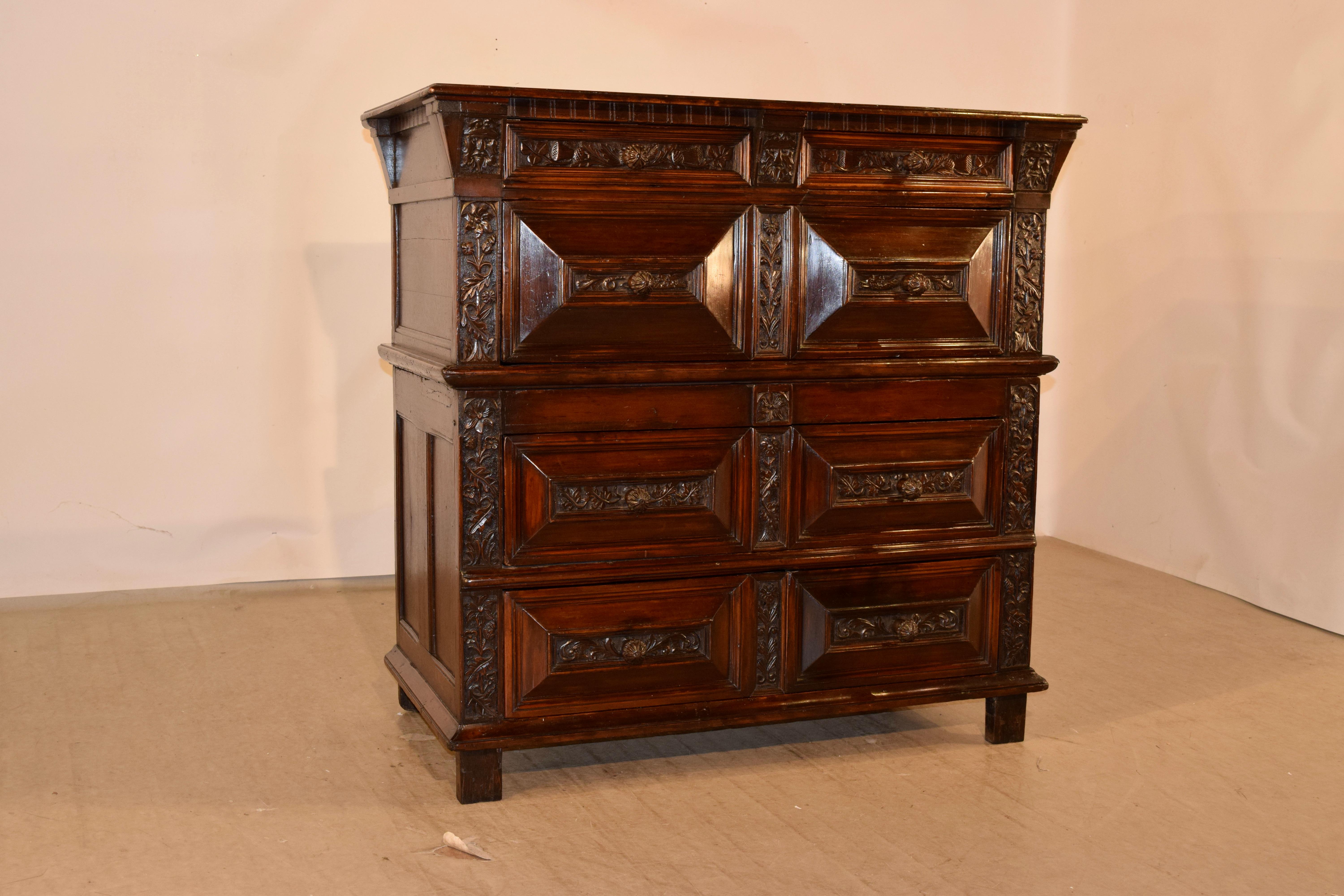 17th century carved two piece chest of drawers from Scotland made from walnut and rosewood. The top is banded and has a beveled edge surrounding a four board top. The sides are hand paneled, and the front of the case contains two small drawers over
