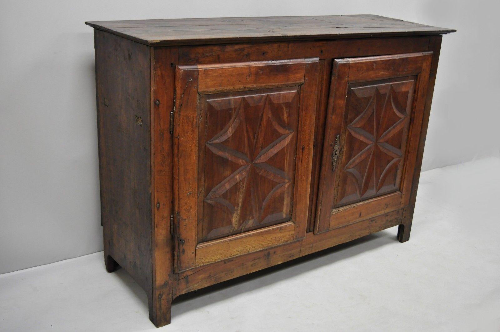 17th century carved walnut Italian Baroque two-door credenza cabinet buffet. Items features hand carved door panels, interior shelves, authentic aged and distressed patina, 2 swing doors, very nice antique item, circa 17th Century. Measurements: 40