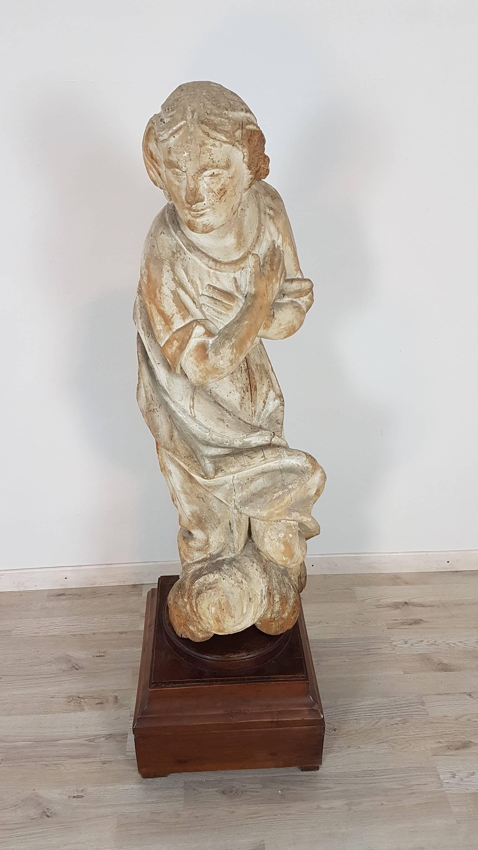 Rare wooden Madonna. The Madonna is represented with great grace in the face and in the pose, the simple dress in the lower part almost tends to wrap it with a movement of the drapery. The backside part is hollow and this suggests that the statue