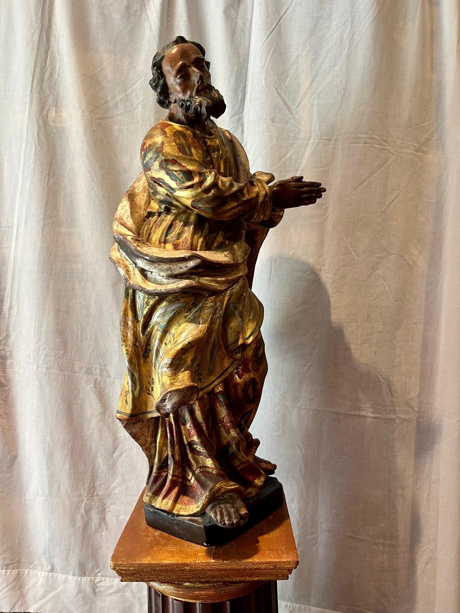 Large Saint John the Evangelist figure created in the workshop of Franz Matthias Hiernle in Mainz, Germany. The superbly carved and highly decorated slender figure, in an elegant and balanced posture with one foot forward, is wrapped in a decorative