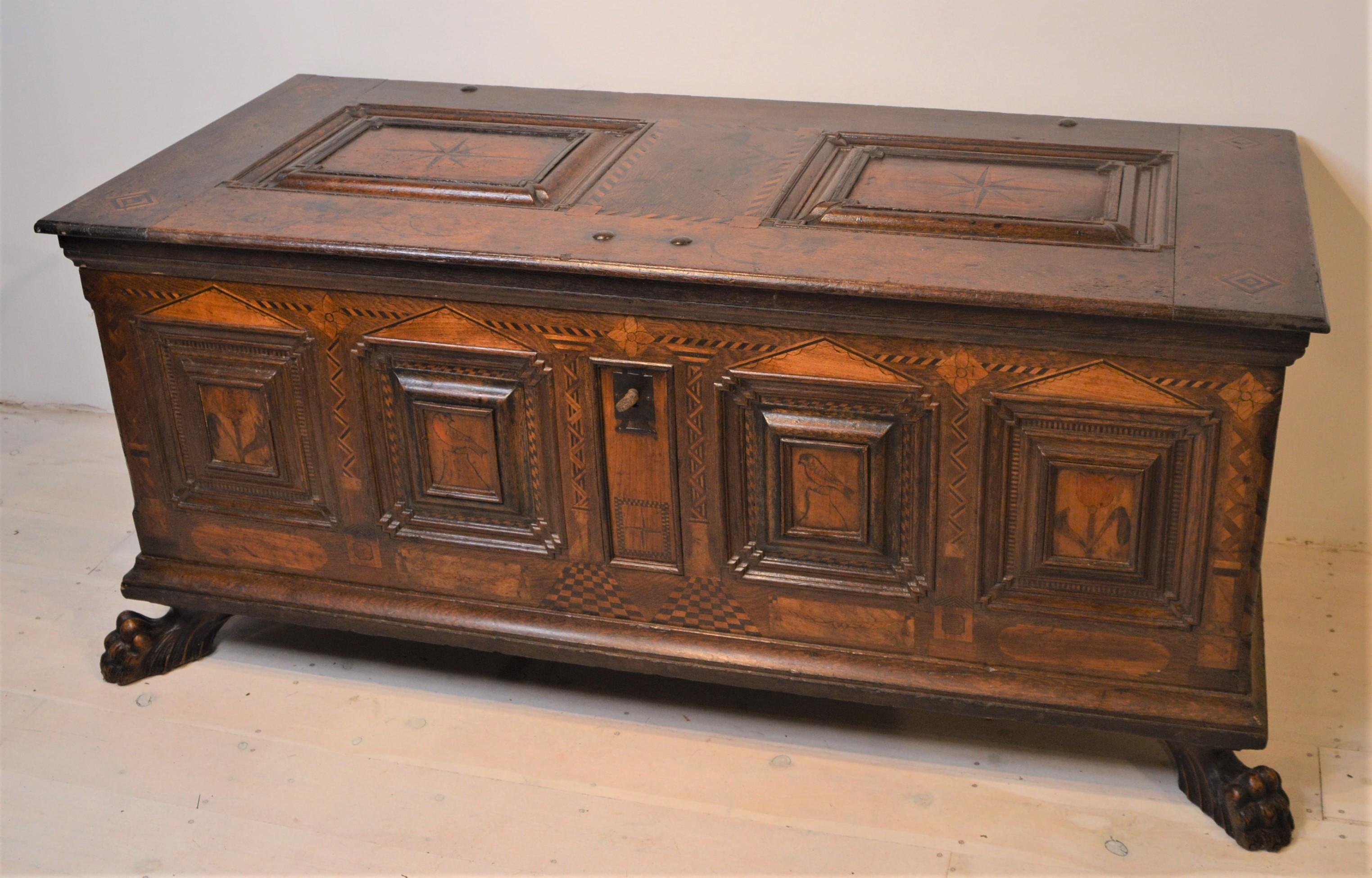 Superb, early 17th century marriage chest in oak , walnut and exotic woods, inlaid with birds and flowers. These exotic veneers include boxwood, bog oak, holly and other indigenous timbers.
Once unlocked, the end panel slides up to reveal two