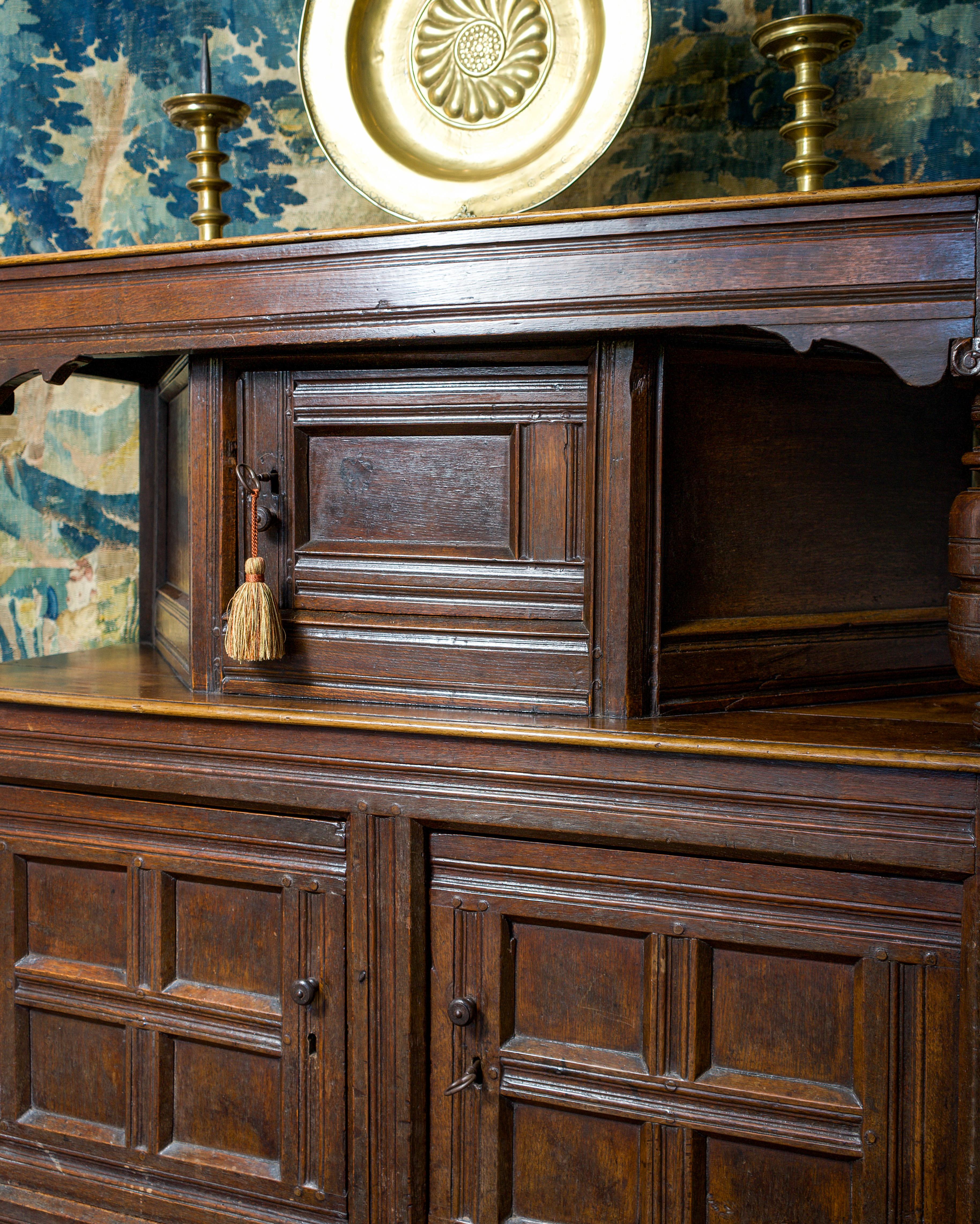 17th century canted oak livery cupboard, with plain cup & cover supports with ionic capitals.
