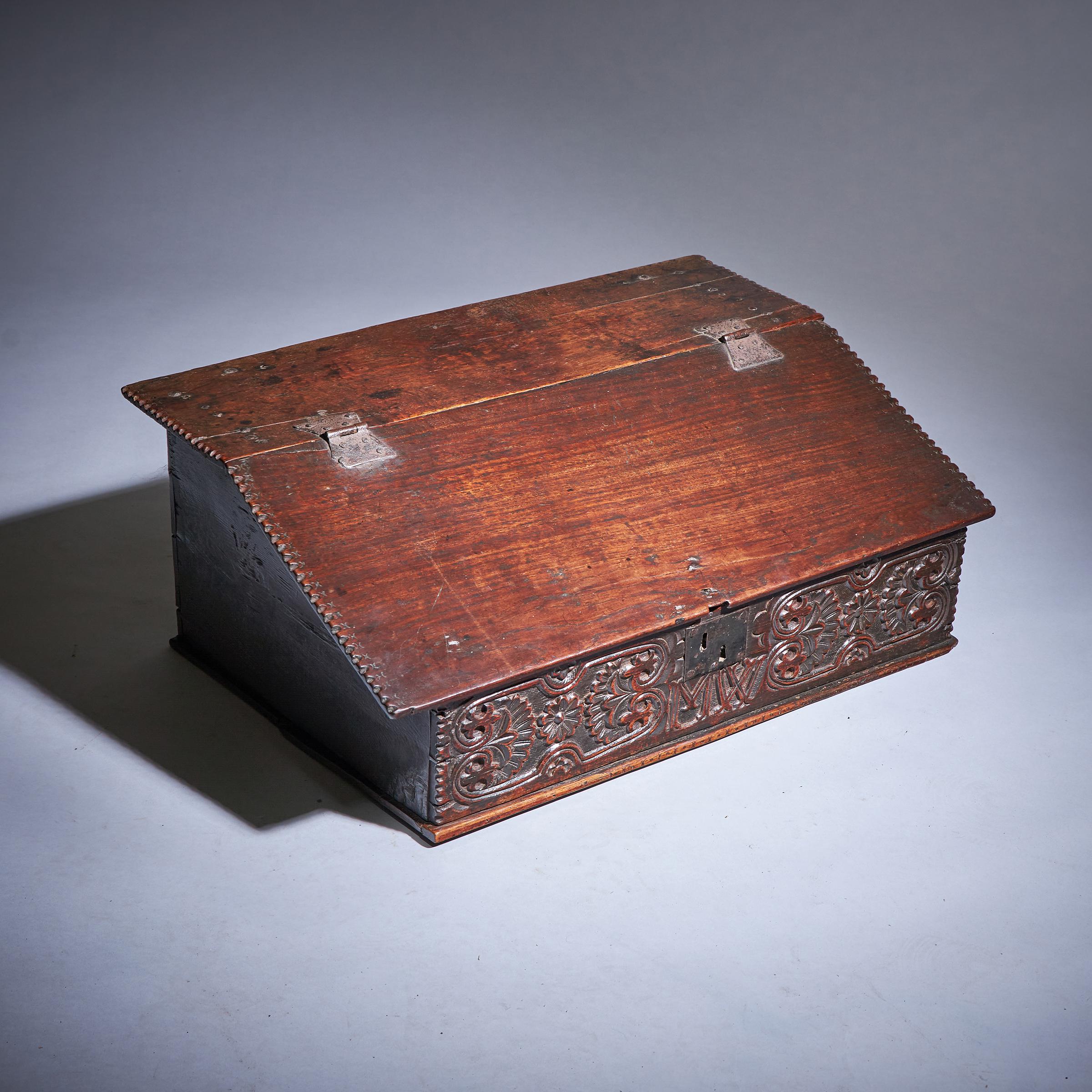 A Rare 17th-Century Charles II Carved Oak Writing or Desk Box, Circa 1660. England.

The box opens on the original butterfly hinges to reveal a fitted interior of three oak-lined drawers. 

The deep carving to the frieze is very much in the