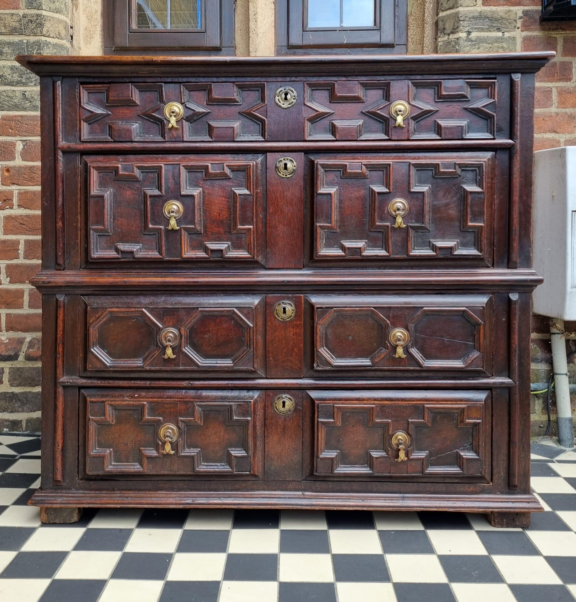 A superb 17th-century Charles II geometric chest of drawers. It features a rectangular planked top . The chest has four long drawers, lined with oak ,  brass drop handles, escutcheons. It stands on its original stile feet . Outstanding rich warm