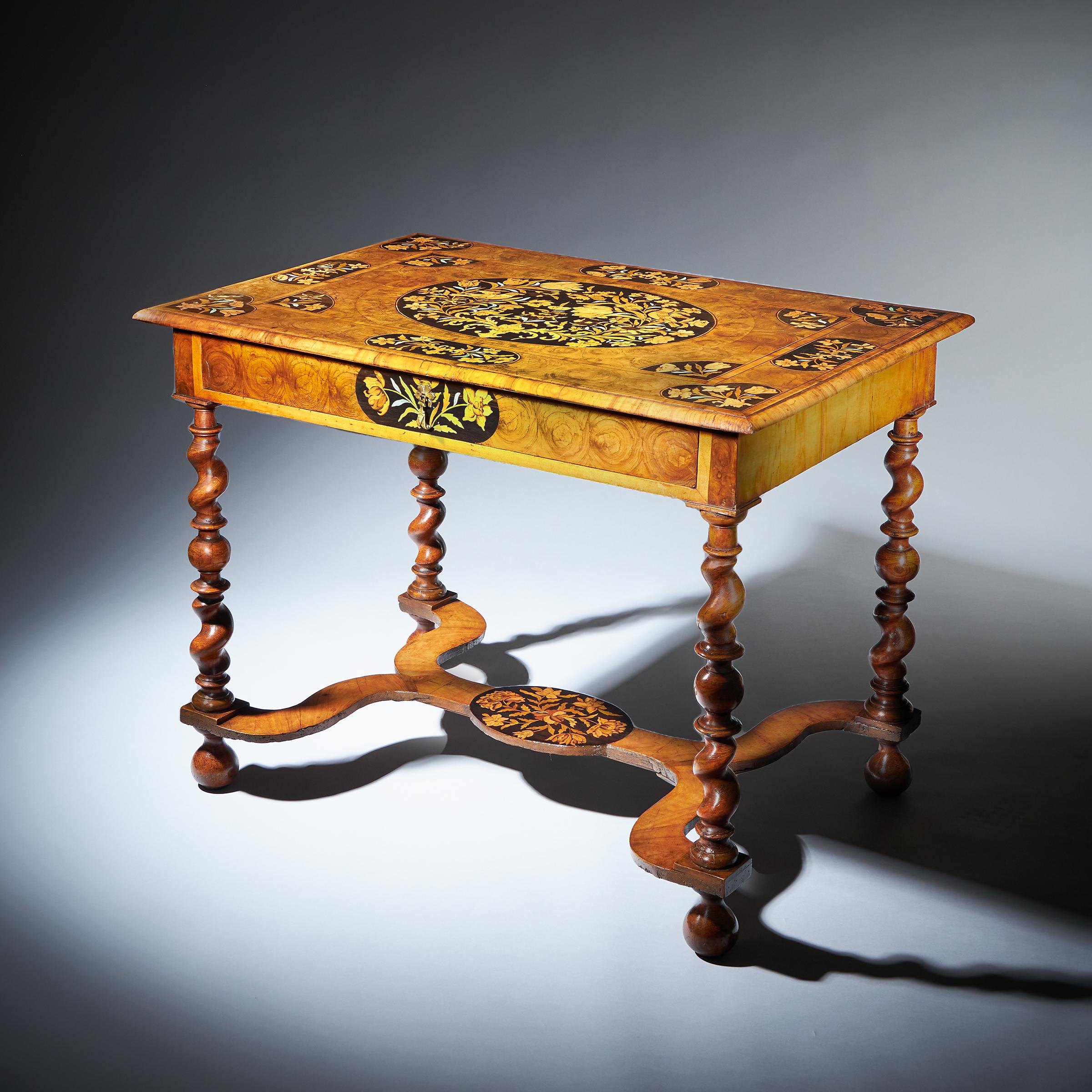 Floral marquetry inlaid olive oyster and ebony side table, attributed to Gerrit Jensen (fl.1667-1715), London, circa 1680. Incorporating Olive Oyster, ebony, stained bone, holly, figured olive walnut and tulip. The rectangular top is inlaid with a