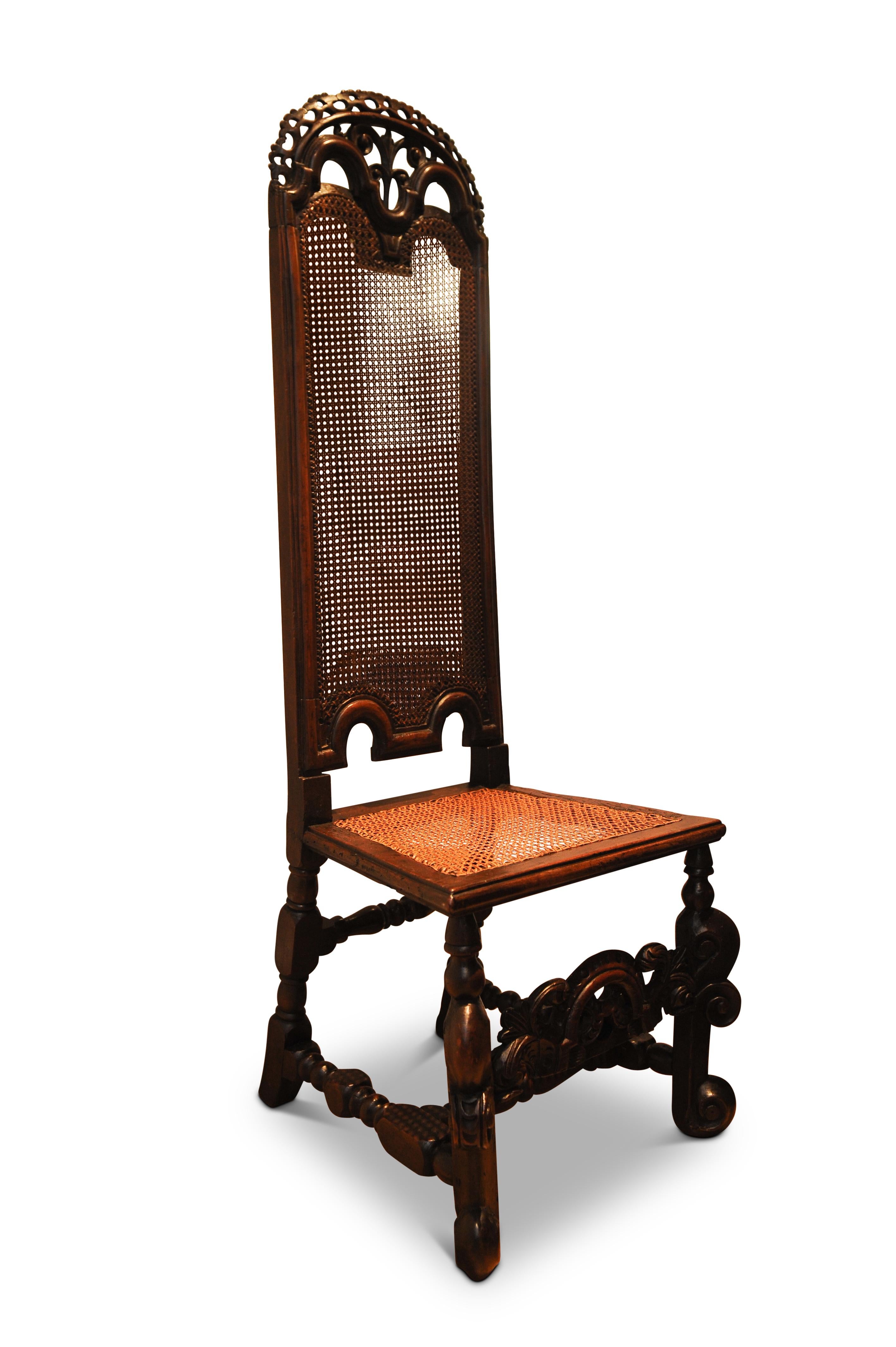 A Beautiful and Well Preserved 17th century Charles II Walnut High Back Bergère Decorative Carved Hallway Chair 1680s

This high-back chair made from walnut dates to around 1680. The crest rail is elaborately carved. The base is then elaborately