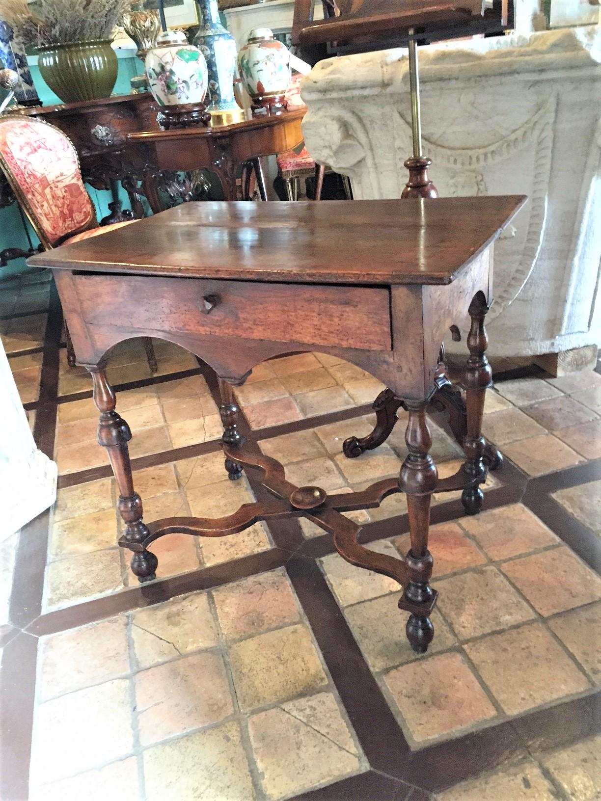 A 17th century antique beautifully carved Charles II walnut table baluster legs joined by a stretcher, standing on original turned bun feet. It's not an oak somber table, the walnut gives it much charm. It could be perfect for a side table, between