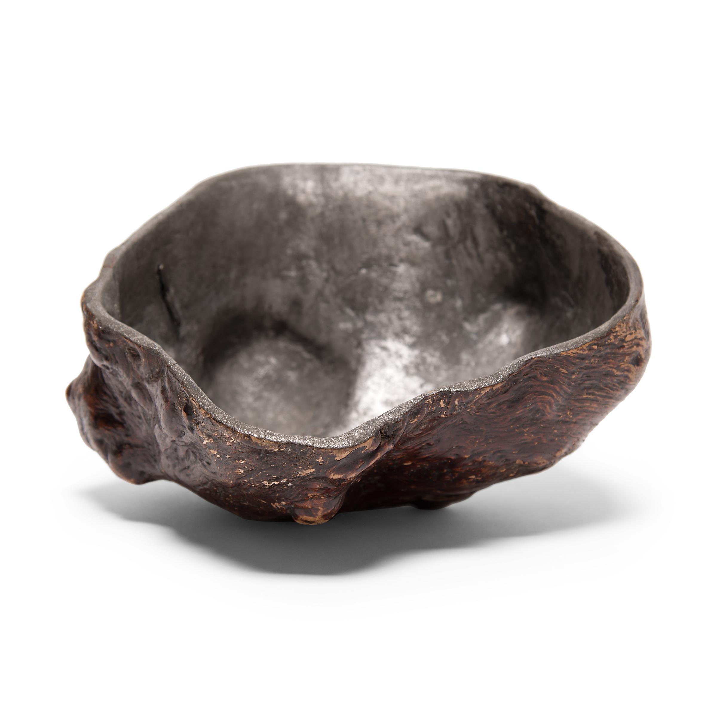 Like brush pots, libation cups are made in a variety of sizes and woods. Some maintain the natural contours of the wood, others enjoy skillful carvings. This grand 17th century natural burl wood example is unusually lined in pewter. The wood has