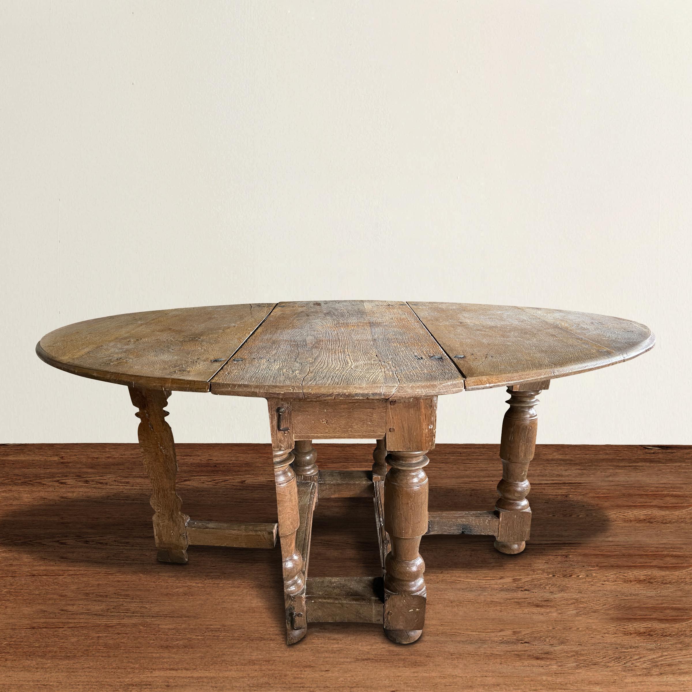 An exceptional 17th century Danish Baroque oak oval gateleg table with four skilfully turned legs, two of them being cut in half vertically allow them to swing open the gatelegs. The table is very versatile and can be used as a small dining or