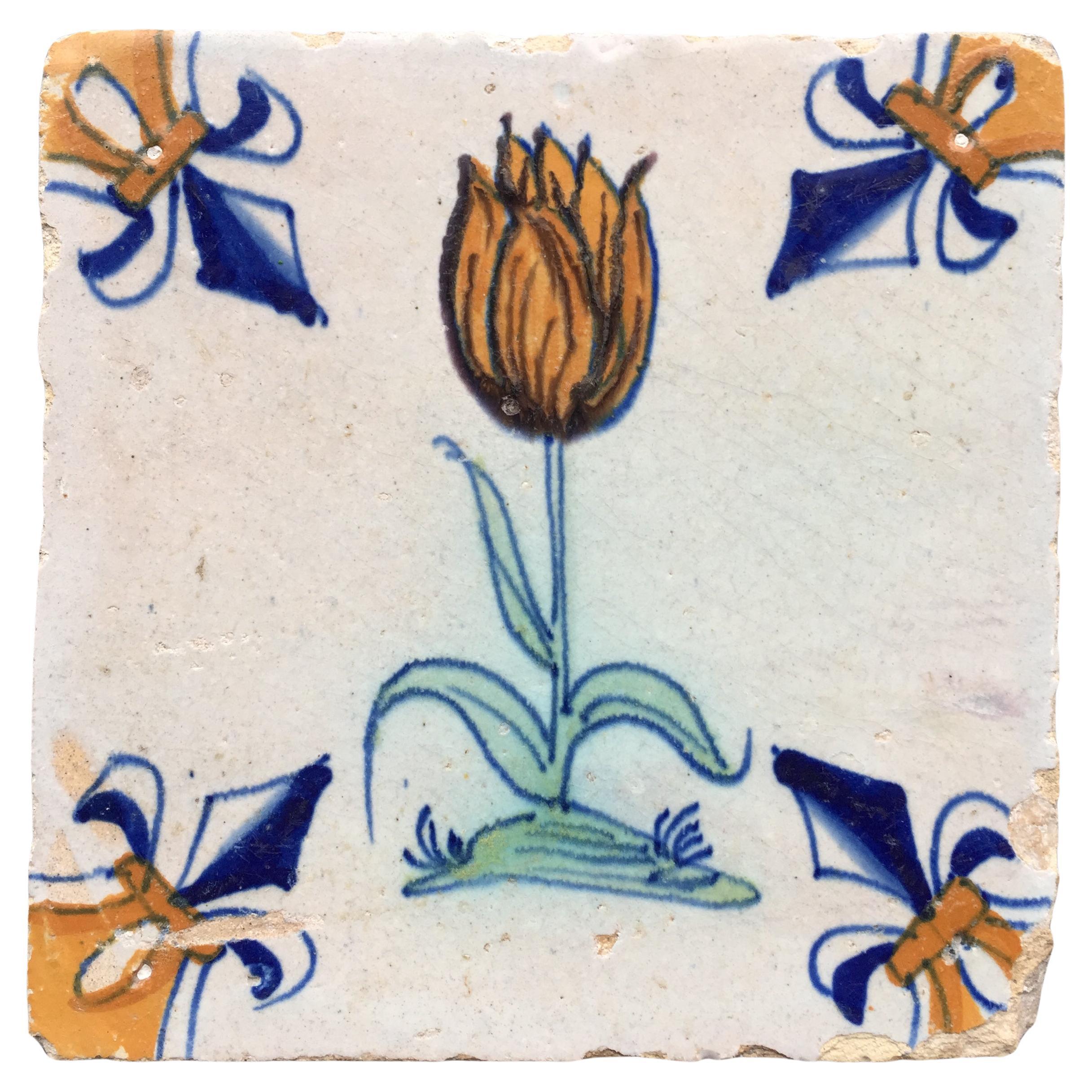 17th Century Dutch Delft Tile with decoration of a flamed orange tulip For Sale