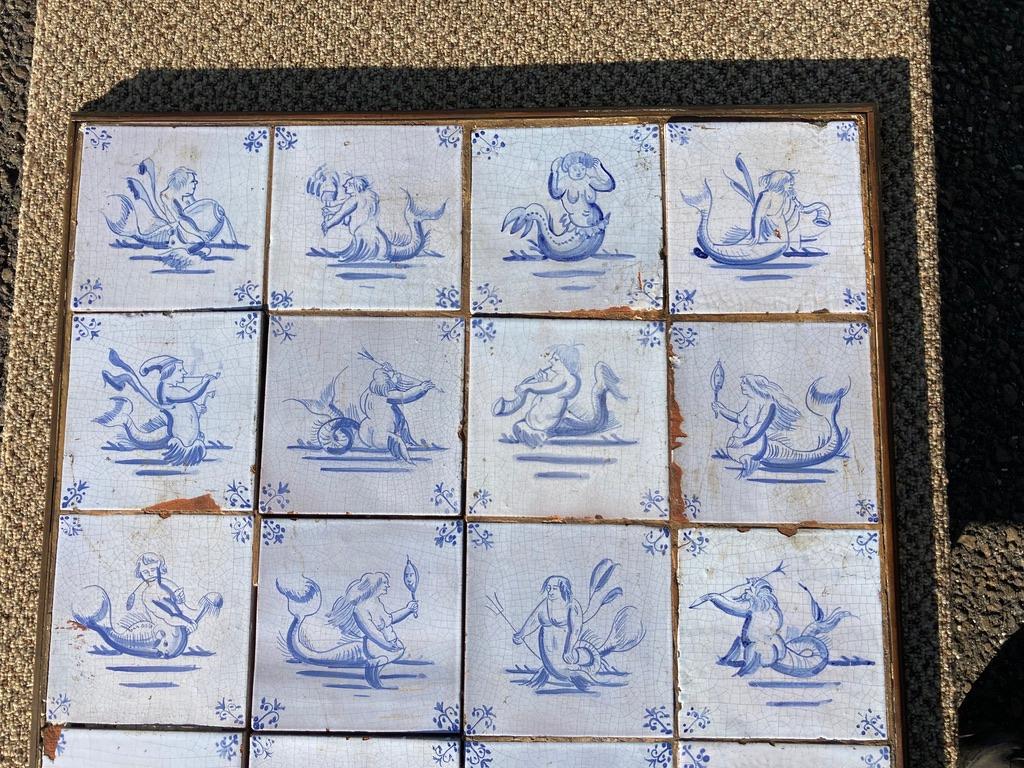 A wonderful and rare collection of 20 mid-17th century Dutch Delft tiles set into a 19th century bronze frame that may have served as a table top. It is rare to find a large group of this theme, mermaids, mermen and sea serpents. This would make a