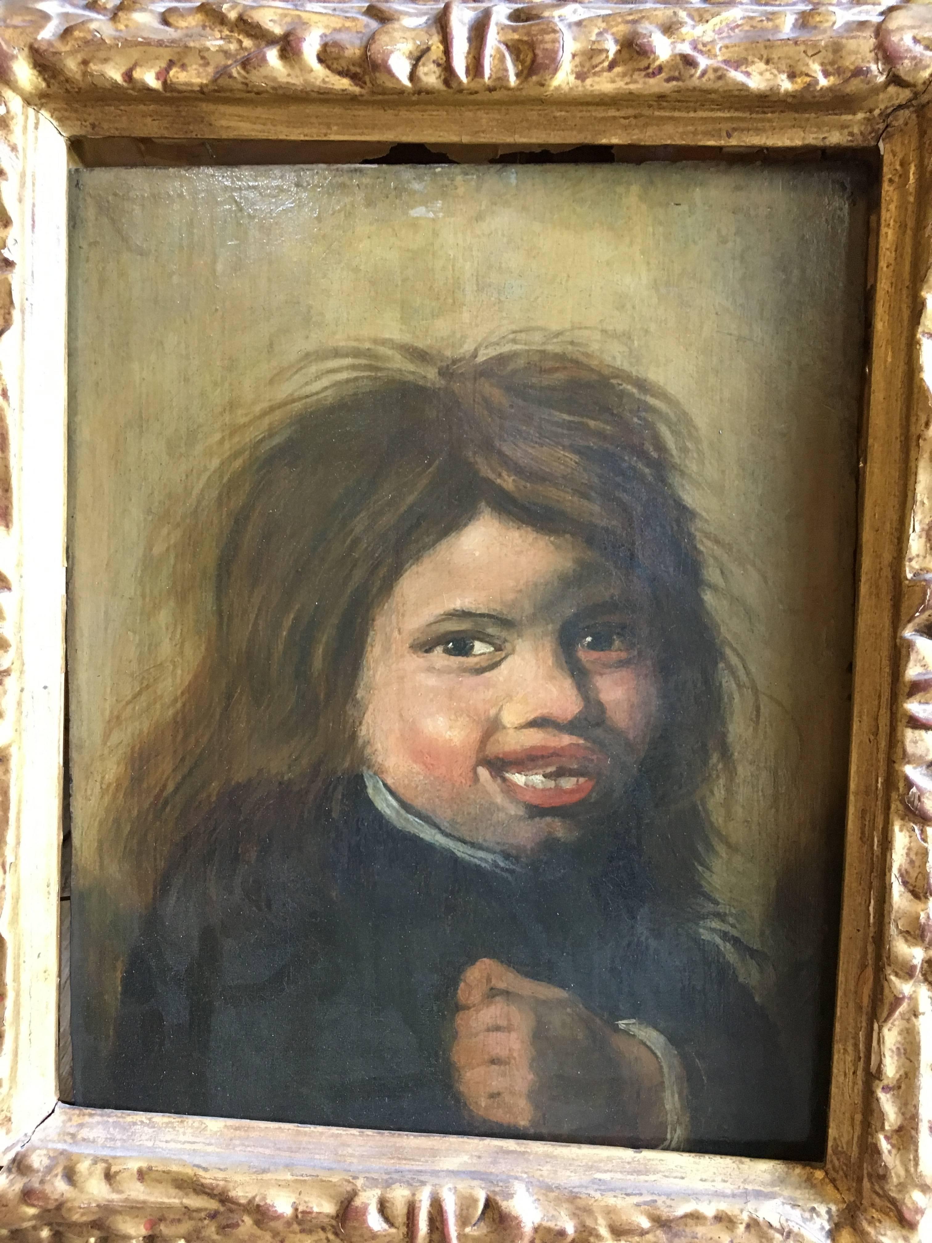 A charming 17th century Dutch or Flemish oil-on-board portrait of a “street urchin” in a period giltwood frame. These studies known as “Tronies” depicted unattractive people in humorous poses and were popular in that period. This particular one is