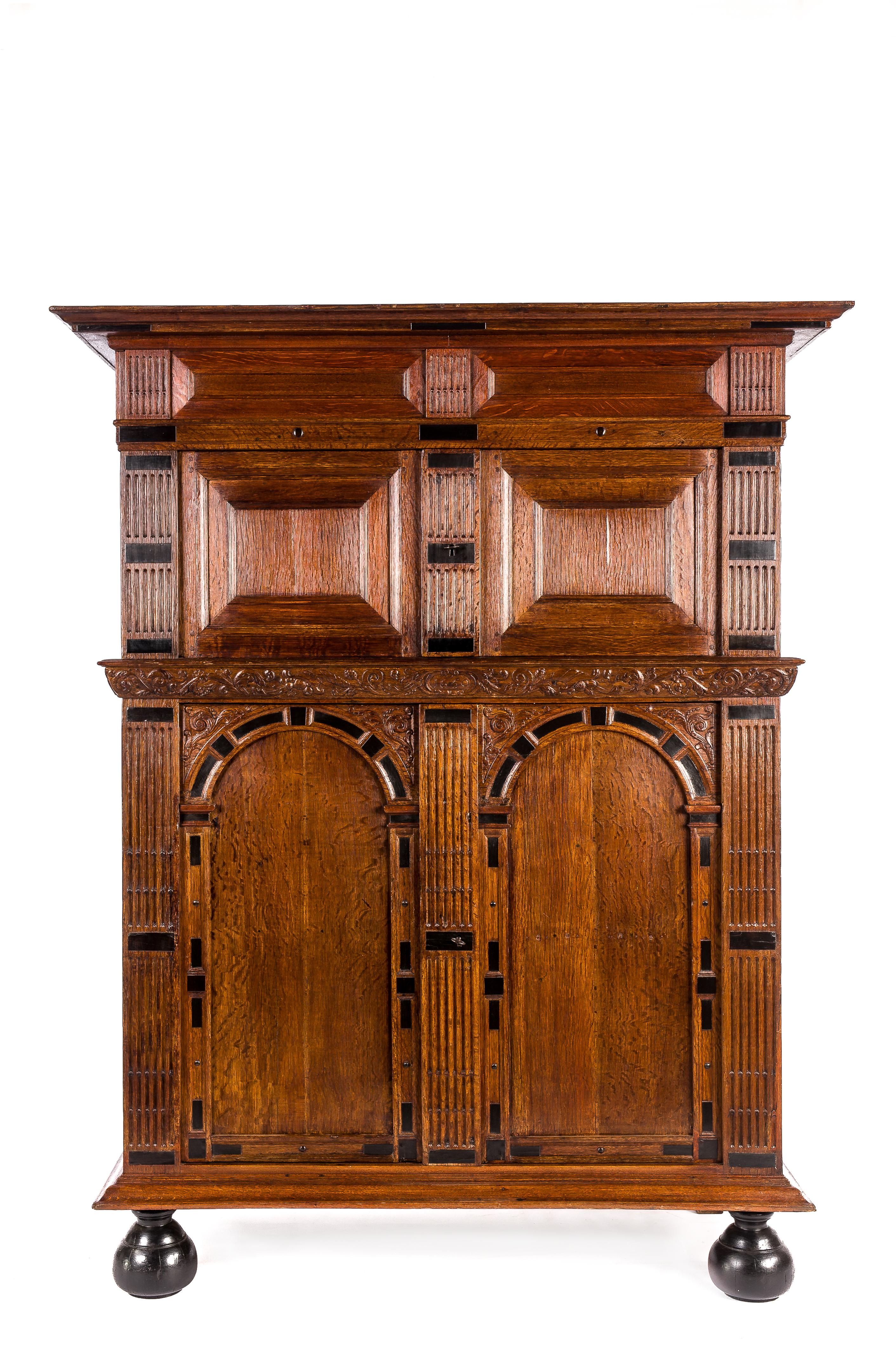 This extraordinary cabinet is made of the finest watered oak in the tradition of the Dutch Renaissance during the “Dutch golden age” 
It is a four-door cabinet made in the Provence of Utrecht in 1660 as is dated on the piece. The arched doors and