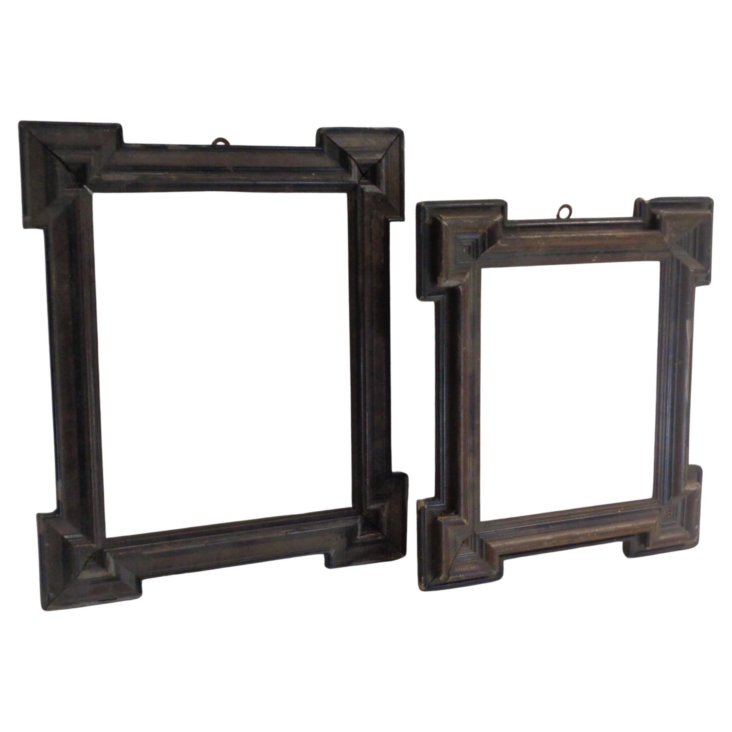 A near pair of carved wood frames w partially ebonized detailing in the 17th century Dutch style. European in origin. Circa 1880-1900. Larger frame measures 15.75