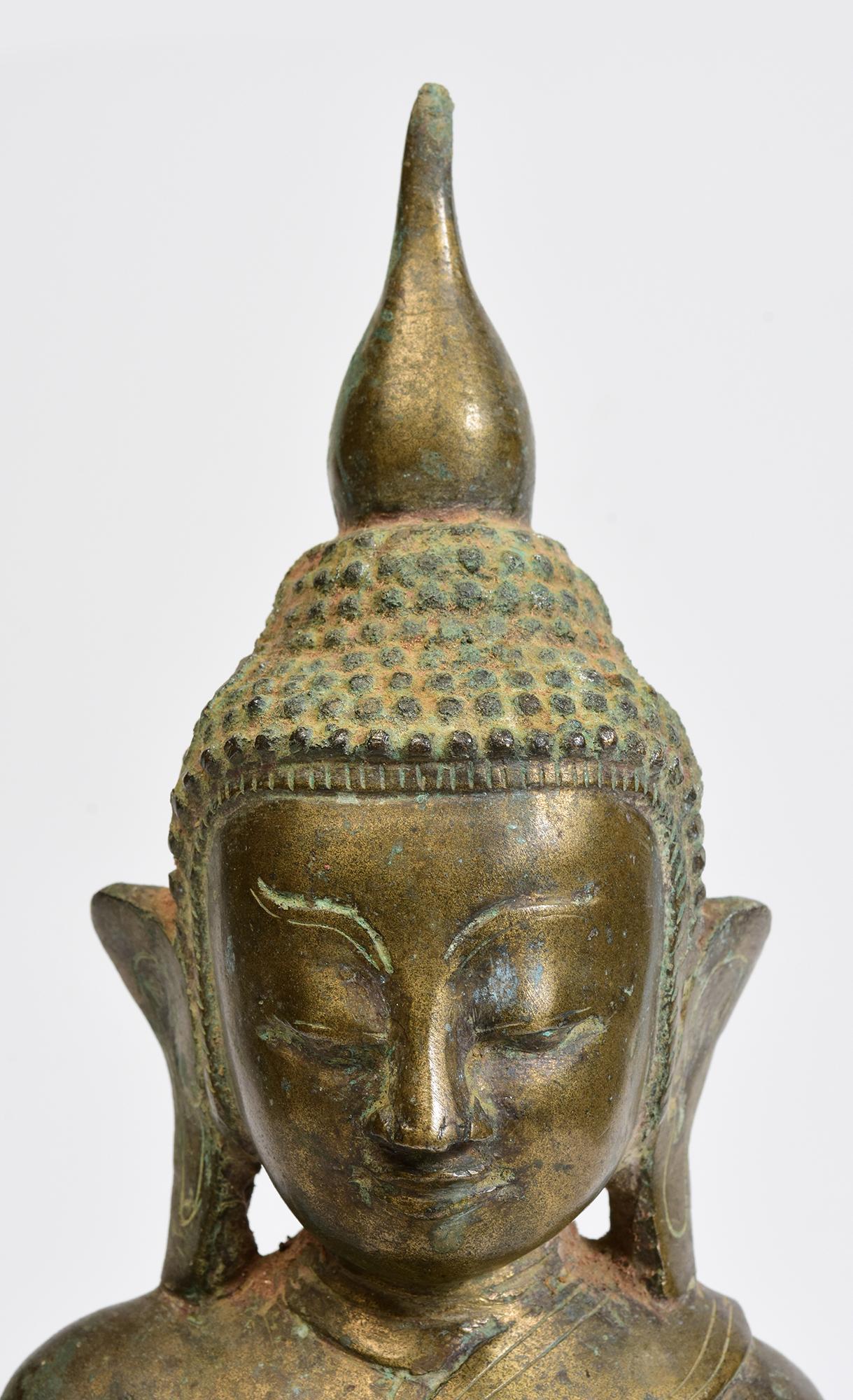 Antique Burmese bronze Buddha sitting in Mara Vijaya (calling the earth to witness) posture on a base.

Age: Burma, Early Shan Period, 17th Century
Size: Height 39 C.M. / Width 18.9 C.M. / Depth 10.3 C.M.
Condition: Nice condition overall (some