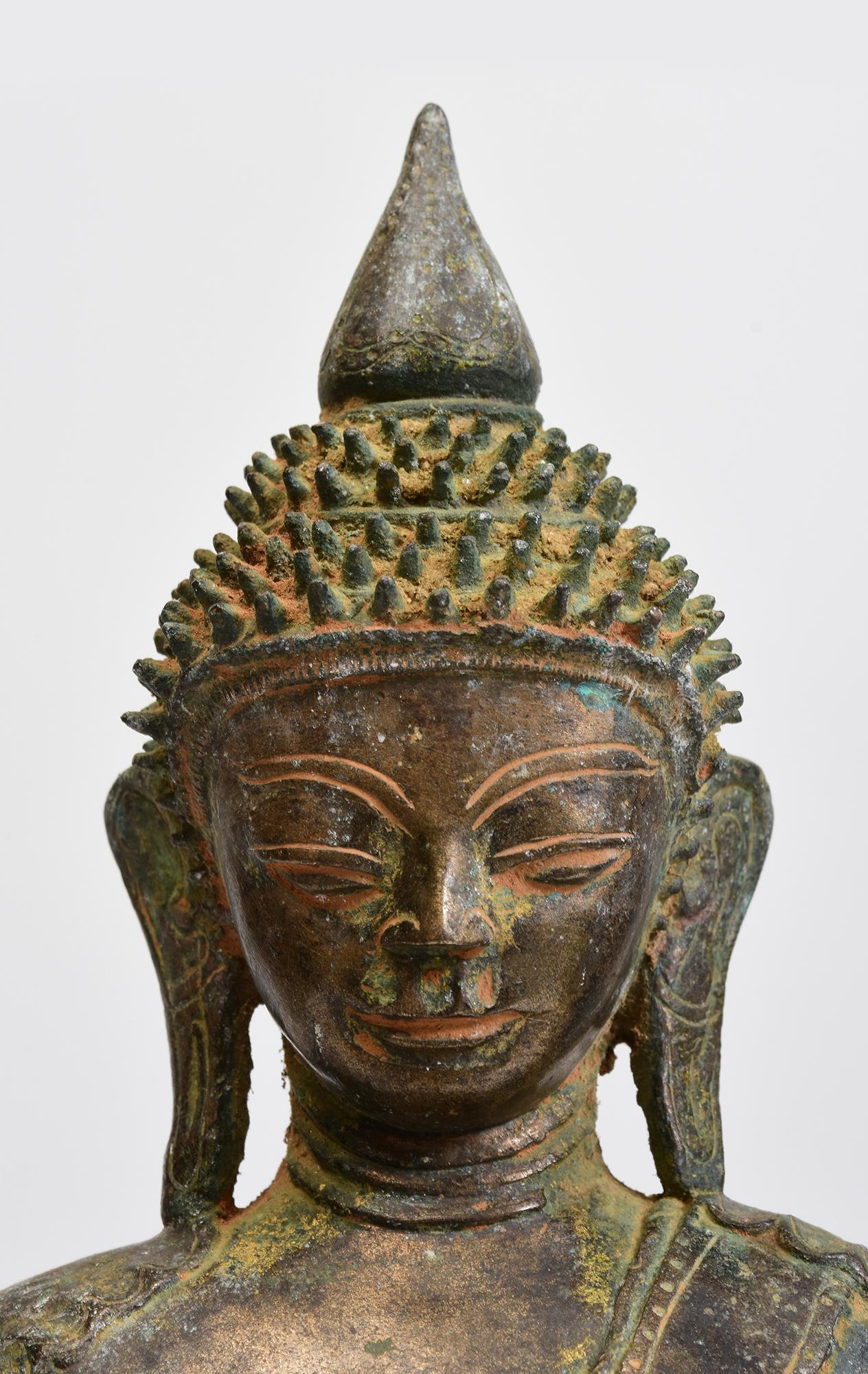 Rare Antique Burmese bronze Buddha sitting in Mara Vijaya (calling the earth to witness) posture on a base.

This Buddha has Indian influence in facial expression.

Age: Burma, Early Shan Period, 17th Century
Size: Height 37.2 C.M. / Width 24 C.M. /