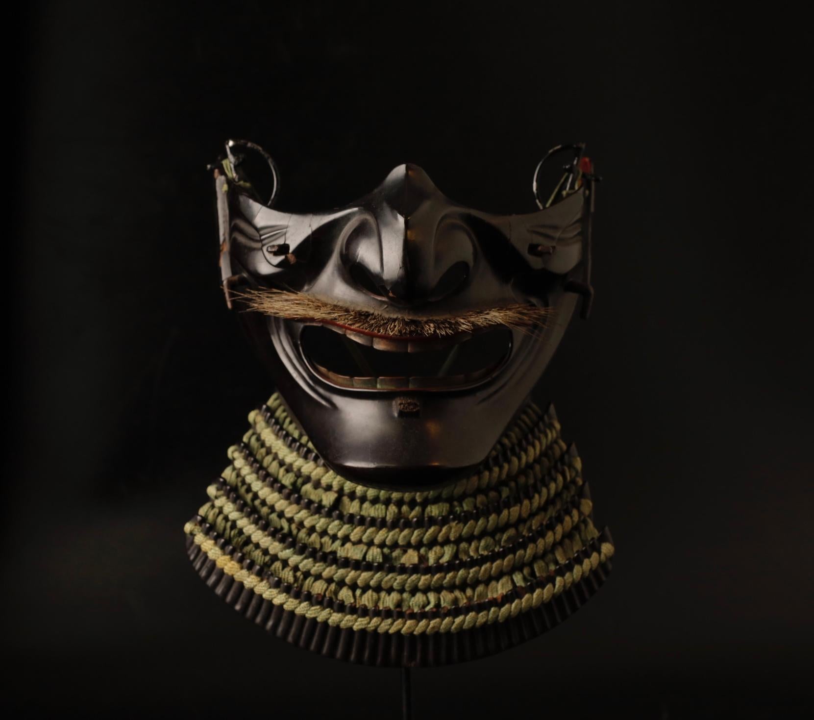 The Ressei Menpo is a striking and fearsome type of Menpo, a face guard that was an integral part of the Samurai armor during the period of the Samurai (1185-1868). Crafted by skilled artisans, the Ressei Menpo is designed to evoke a sense of fury
