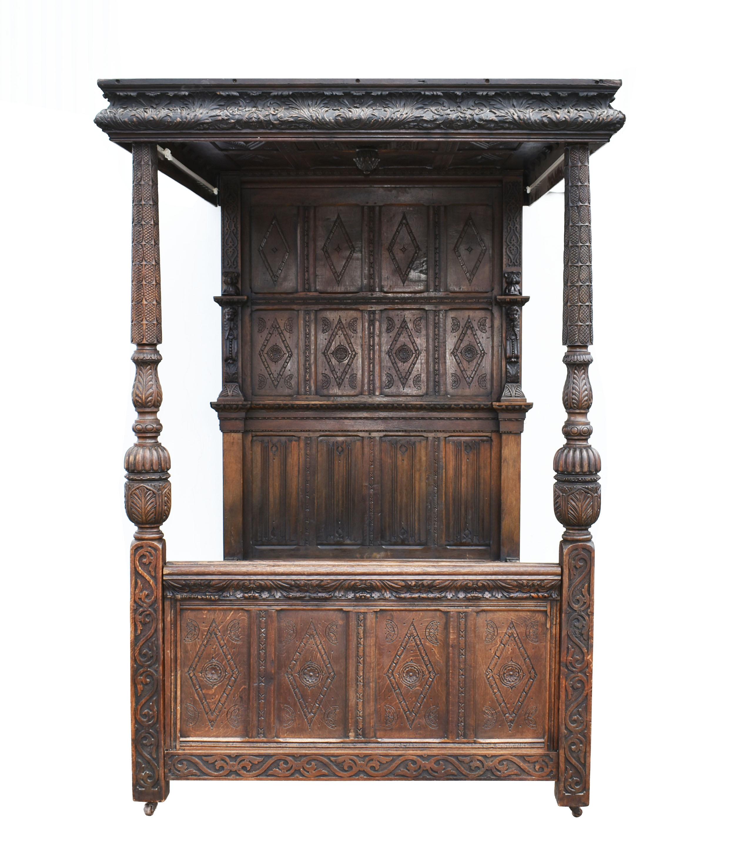 For sale is a fine example of an early 19th century Elizabethan style four-poster bed. Having a deep carved floral pattern around the entire canopy, supported by turned columns featuring bulbous cup and cover, gadrooned, stiff leaf carved supports,