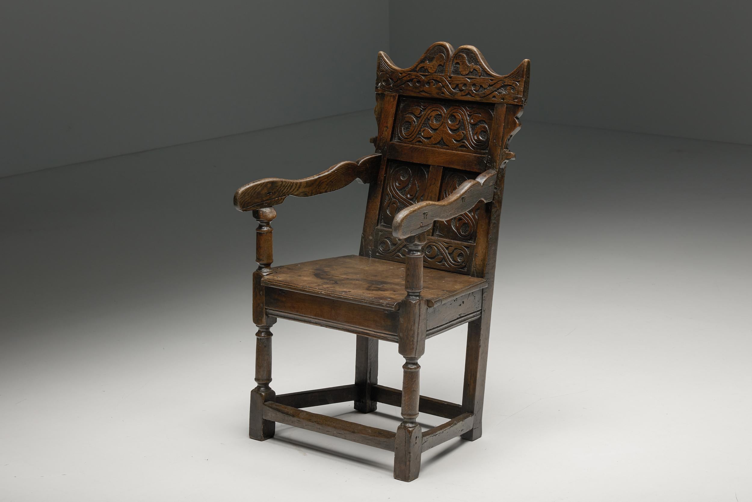 17th-century carved armchair crafted from solid oak, with curved armrests and subtly tilted back. The chair boasts a captivating patina and displays a character befitting its age and history, all while maintaining an excellent condition. Its