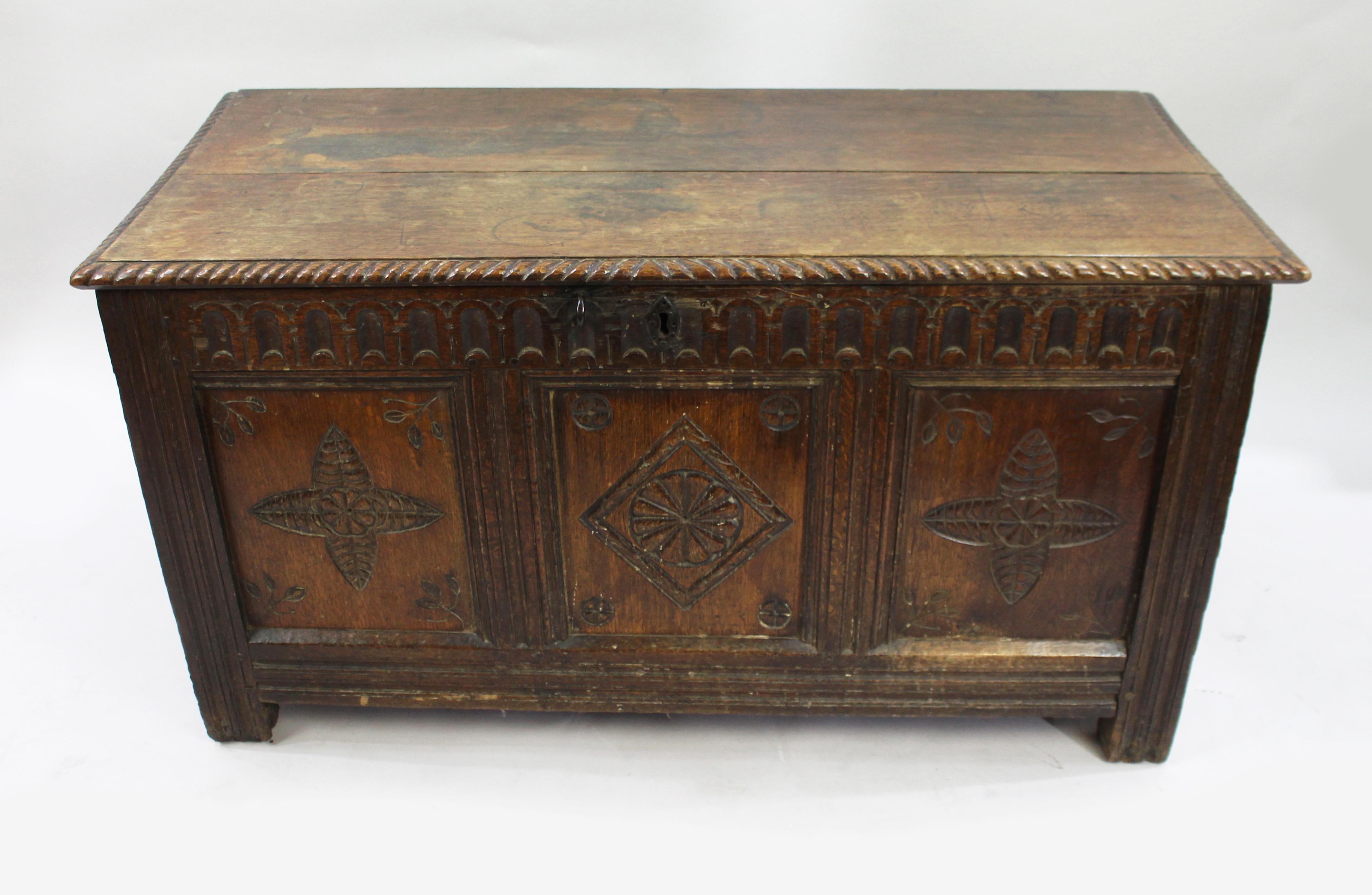 17th Century English Carved Oak Coffer with Foliate and Lozenge Panels

A handsome 17th century English oak coffer, richly patinated and decorated with traditional period carving. The front features three recessed panels, the central one carved with