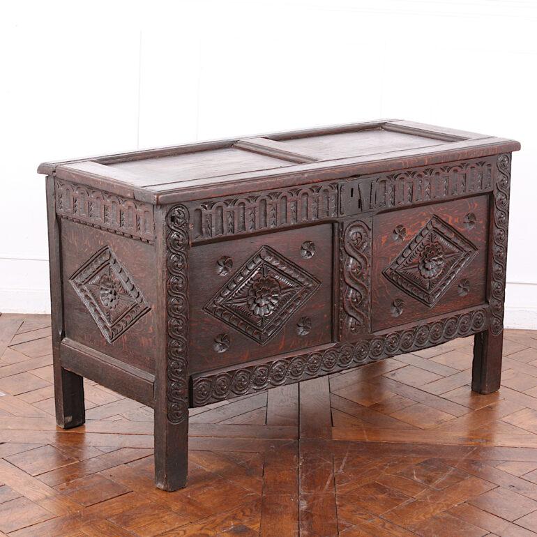 This is a lovely old piece, dating to the late 17th century, with a superb original finish and patina. The chest has geometrically carved panels on the front and sides, set into carved borders. The hinged heavy top of the coffer is comprised of two