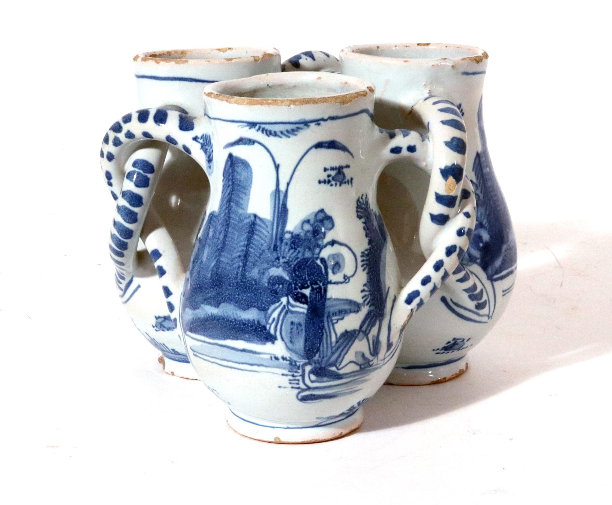17th century English Delftware Fuddling cup,
Probably Southwark or London
Circa 1660-80

The early English delftware fuddling cup has underglaze blue & white Chinoiserie decoration with a single male figure to one side and towering layered