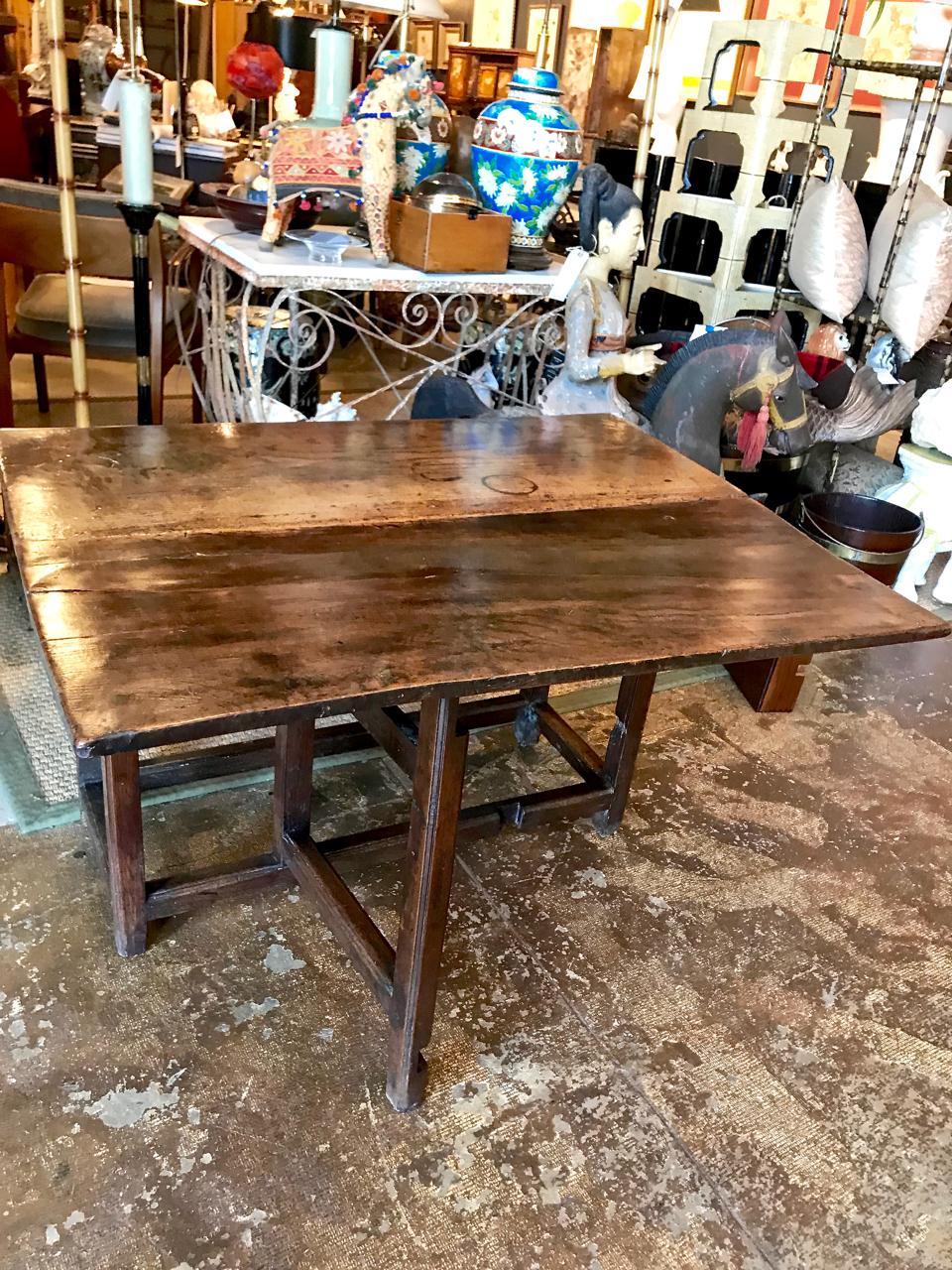 This is a rare English oak and elm single gateleg breakfast table. The table appears to be all original, retaining it's original forged iron hinges and old (if not original) surface. There is a crack to the drop leaf, which is stable. The table is