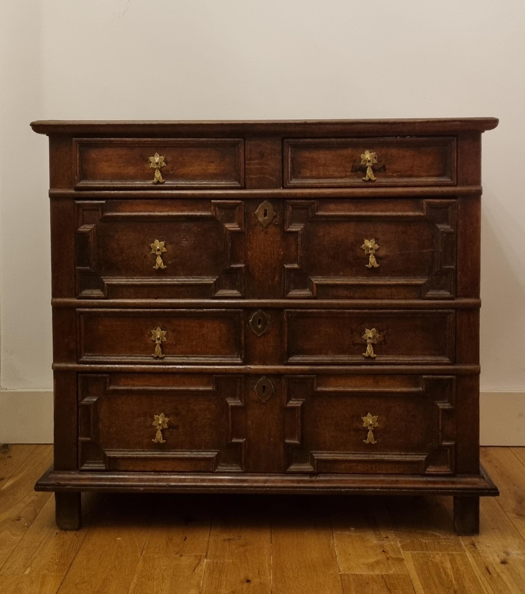 A 17th-century English oak geometric chest of drawers, circa 1680. 

A nice quality chest and boasting a warm colour and patina . The chest has four long drawers with brass fish-tail drop handles, geometric moldings to the drawer fronts, oak
