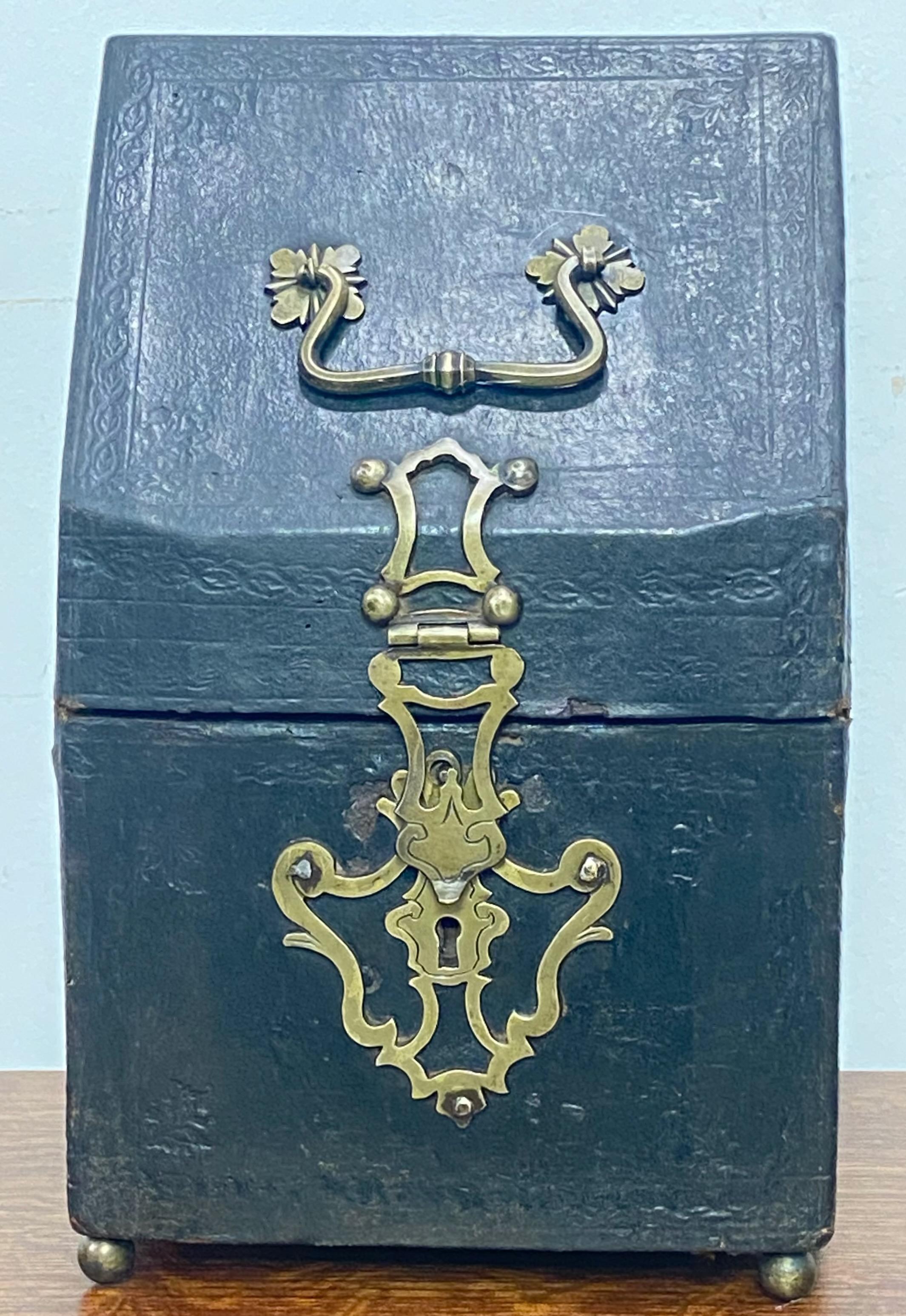 17th century leather knife box converted to a letter box with original brass hardware, sitting on brass ball feet.
Fitted interior lined with 18th century silk fabric.
In very good condition considering its age, has some minor loss to the tooled